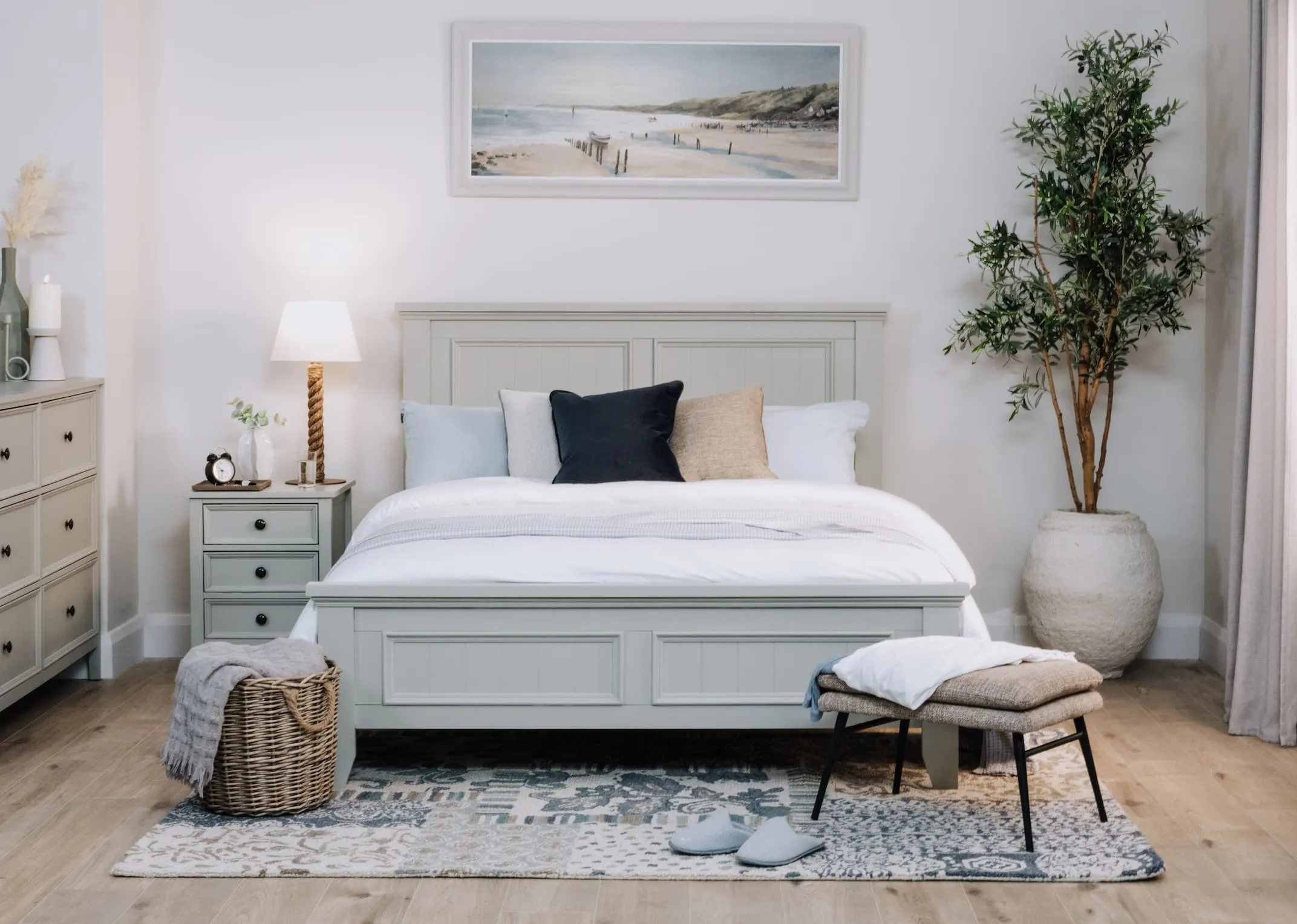 A lifestyle image of the Joseph bed with matching locker and dresser with Barison rug.
