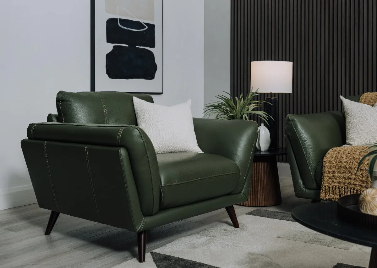 A lifestyle image of the Toscana Armchair witj cream cushion and Kira side table.