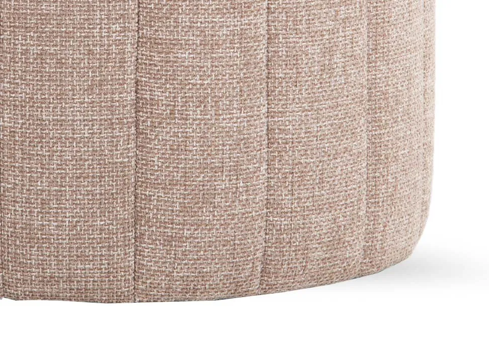 A round beige fabric footstool from EZ Livings Alexo range. Closeup of the seamed pattern