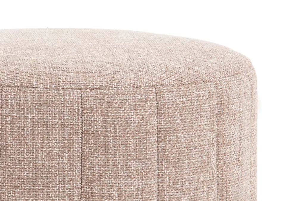 A round beige fabric footstool from EZ Livings Alexo range. Cloaeup of beige accent fabric.