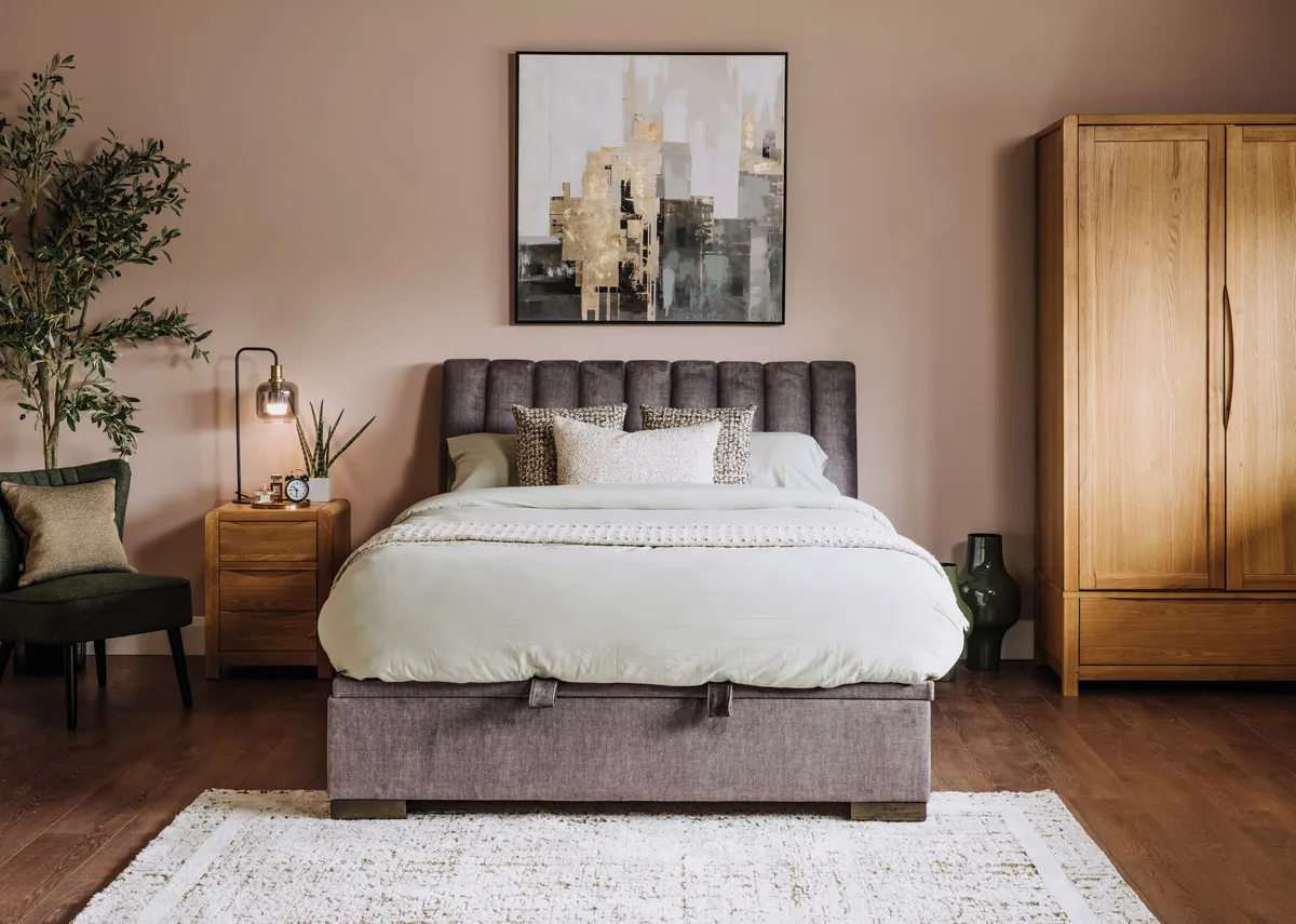 A lifestyle image of the Lancelot bed with Iris wardrobe and locker with Sakura chair.