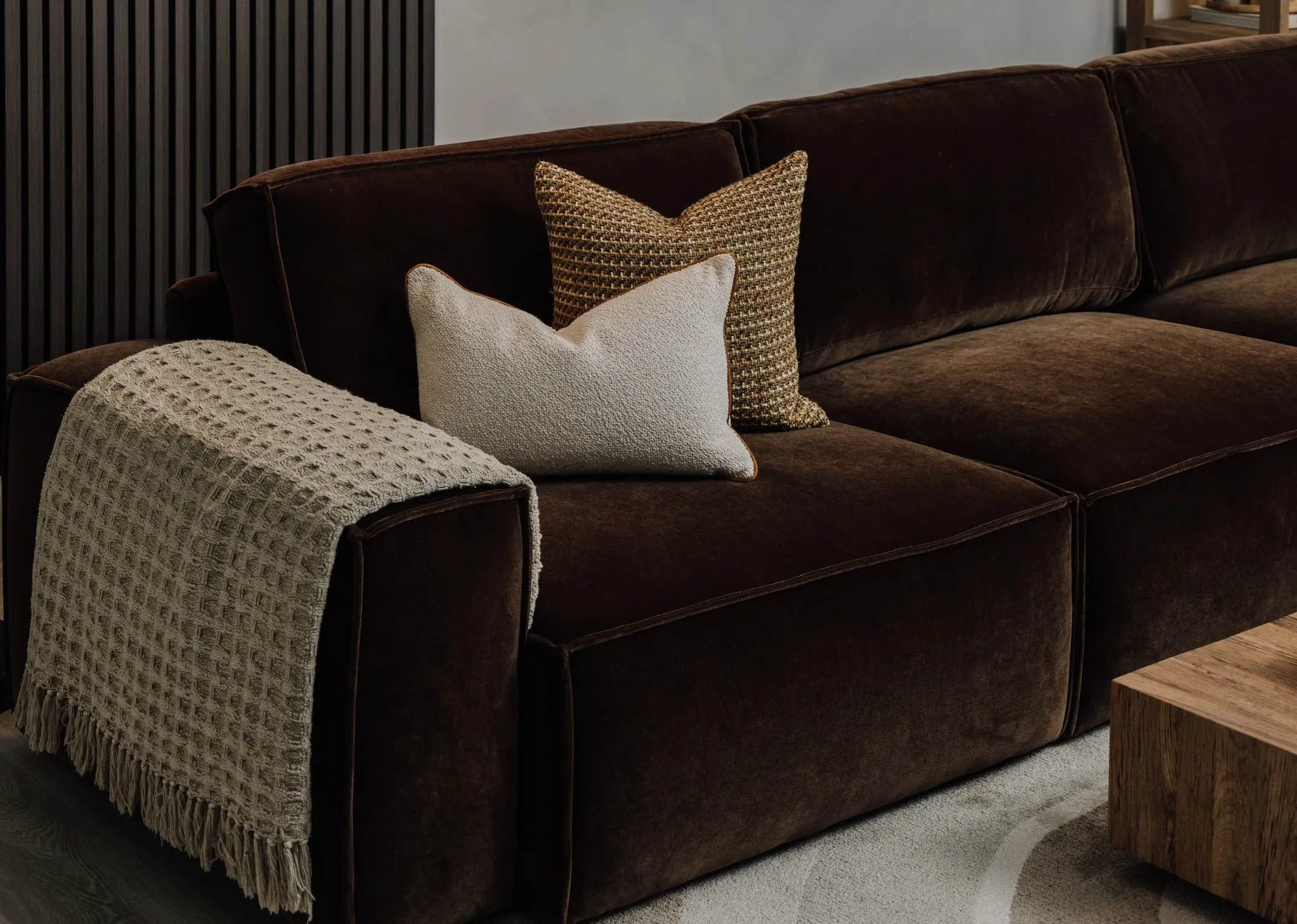 A lifebstyle image of the Denver fabric sofa with knitted cushion and Haley bolster