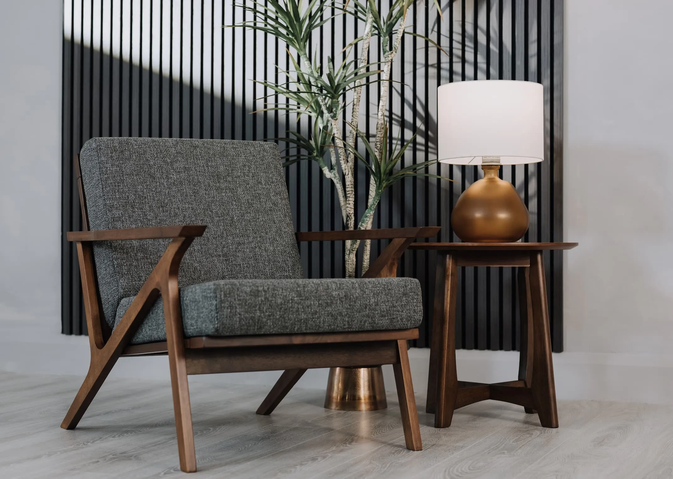 A lifestyle iamge of the Henry accent chair with Henry side table & Alabam lamp.