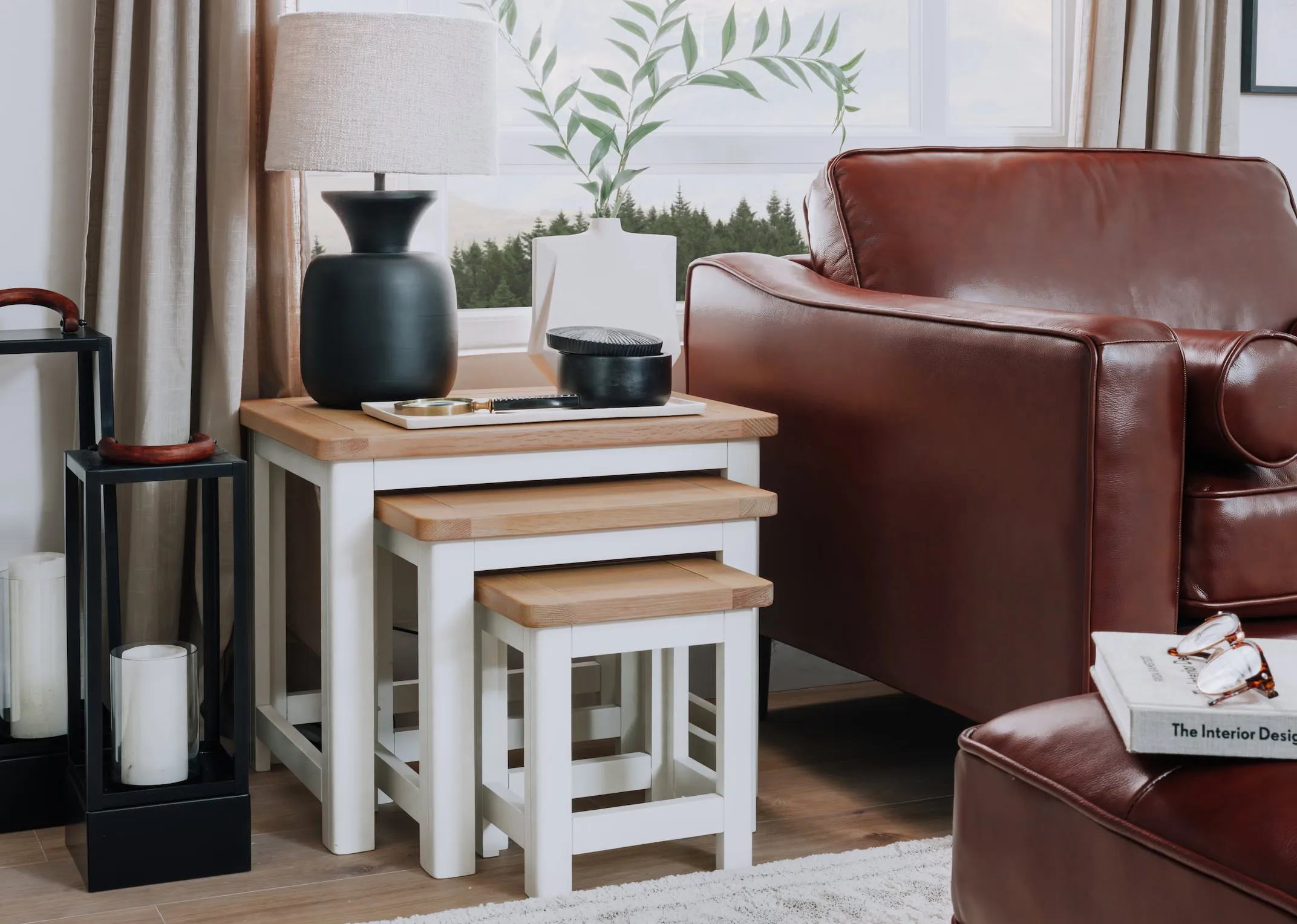 A lifestyle image of the Barleycove nests with Genoa brown leather amrchair with lamp