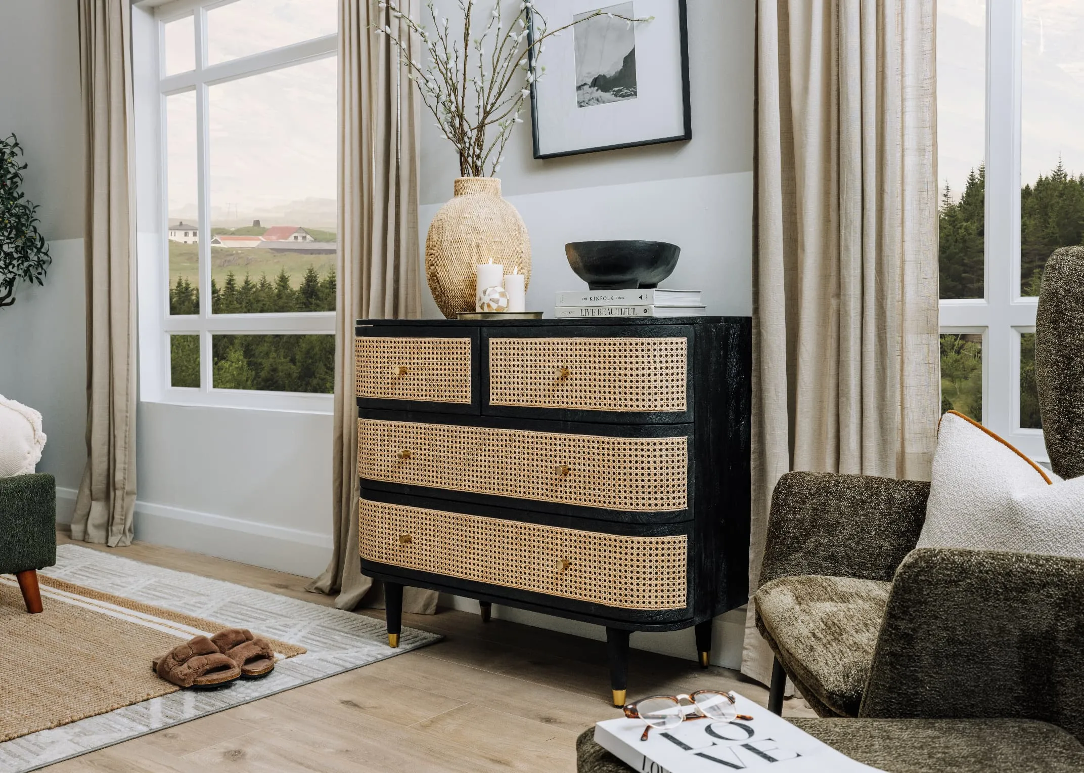 A lifestyle image of the Lenny Chest with vase and Boston chair and footstool.