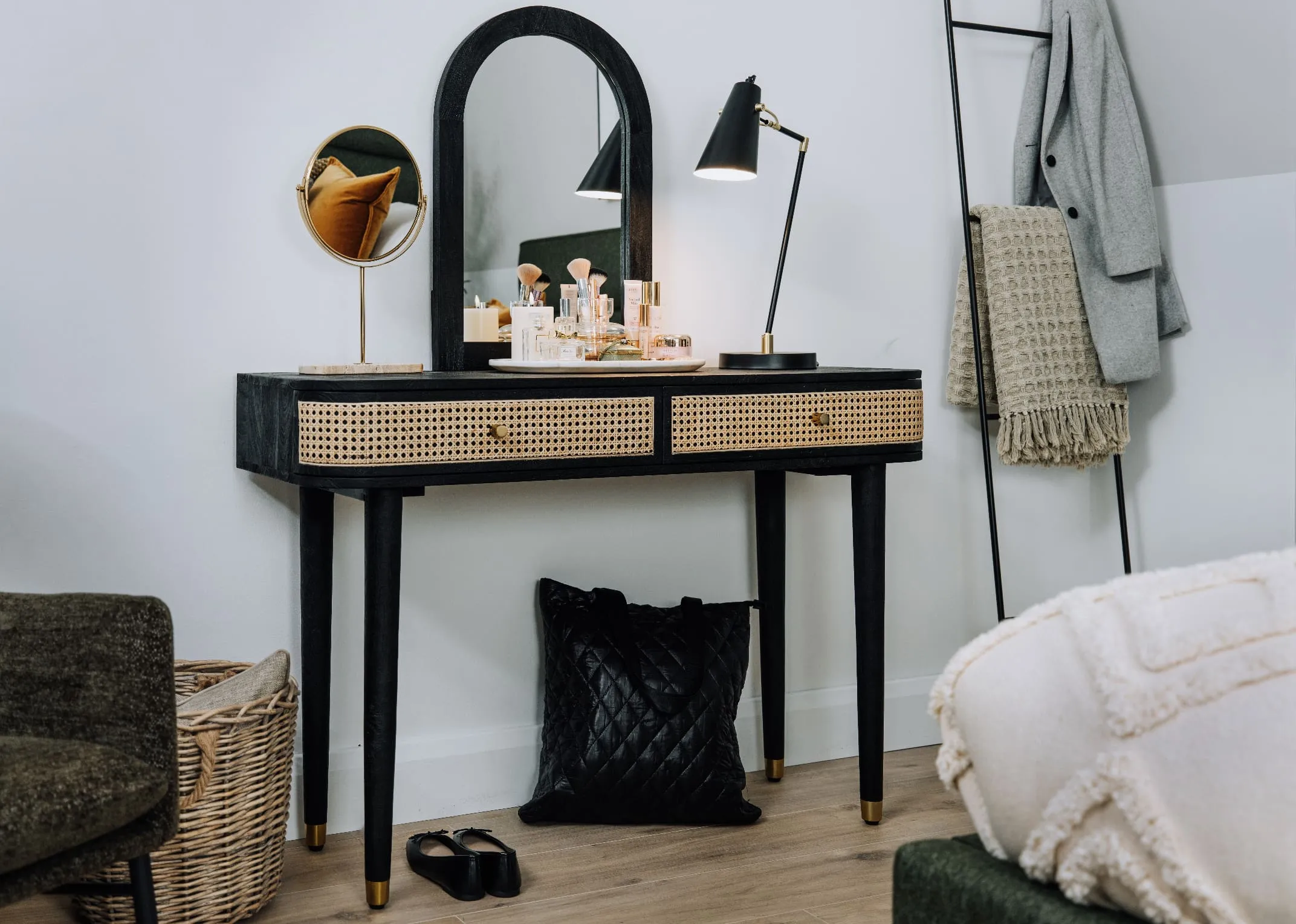A lifestyle image of the Lenny dressing table with Husk lamp and riesco mirror and a seceltion of cosmetics.