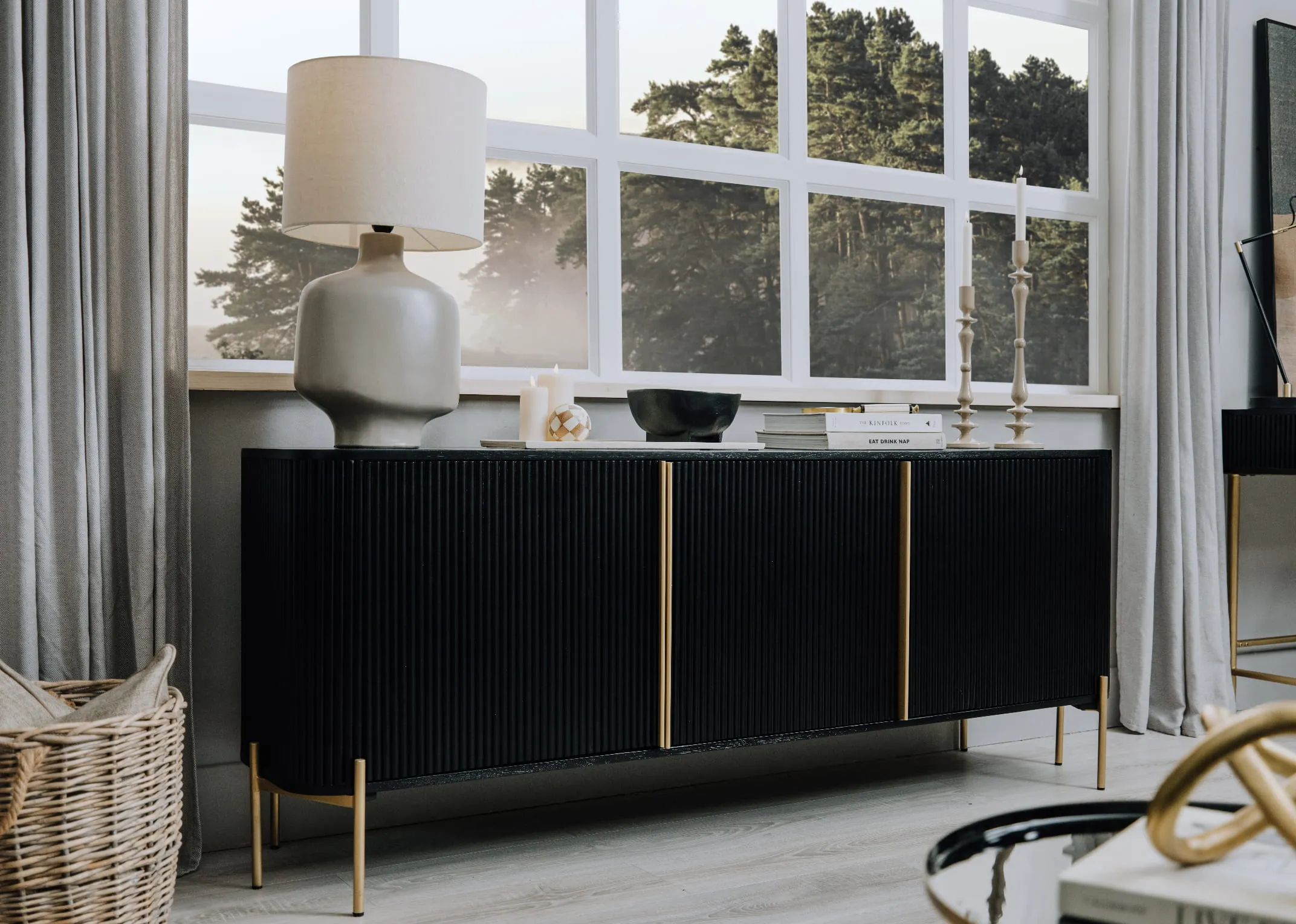 A lifestyle image of the Rego Sideboard with Retro Lamp and Candleholders from EZ Living Furniture.