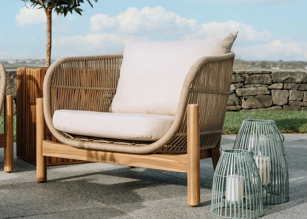 A garden set with a 3 seater sofa with acacia wood frame from EZ Livings La Palma range. Angled view of cream seat and back cushions.
