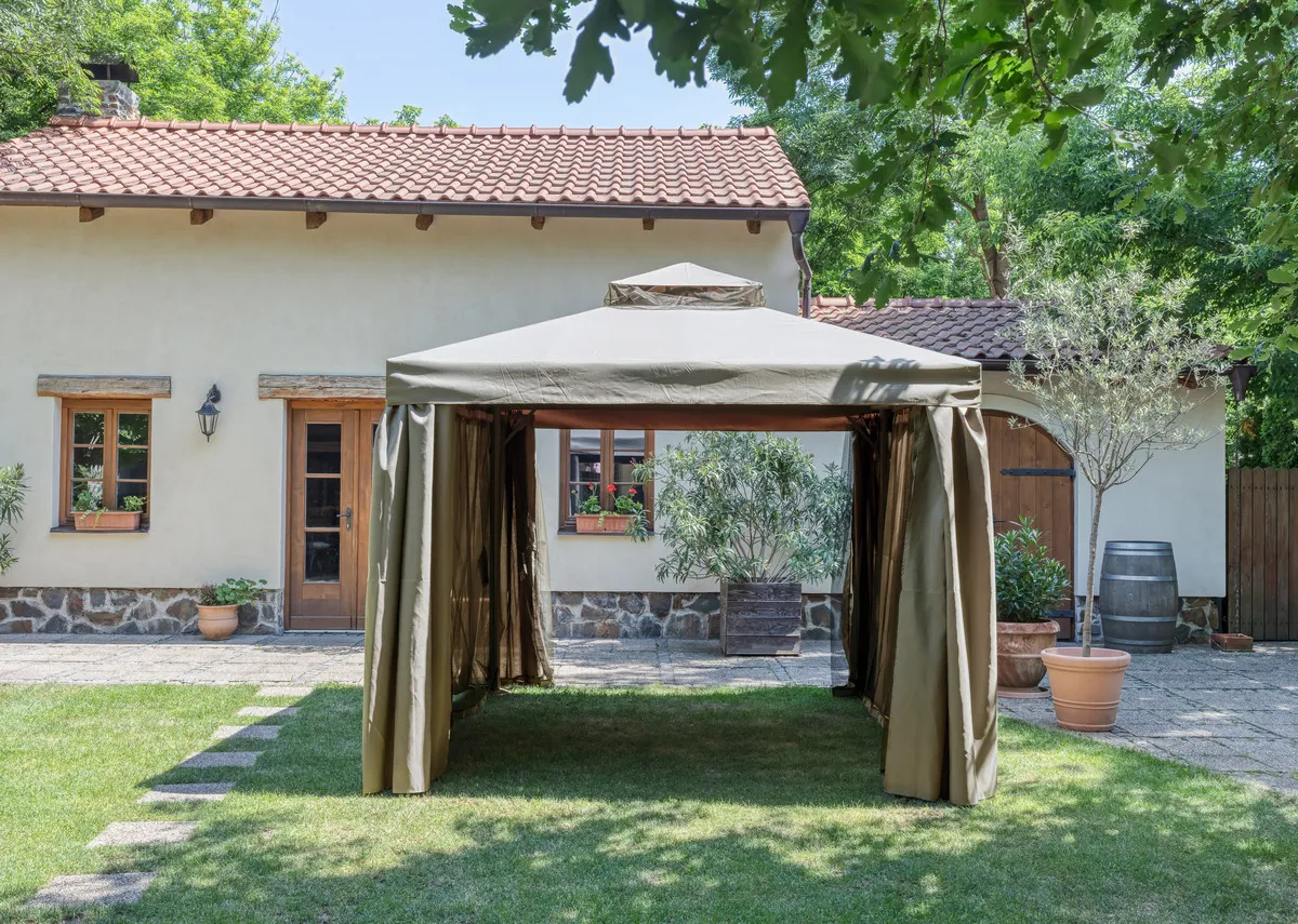 A beige garden gazebo from EZ Livings Alhambra Range. Side view