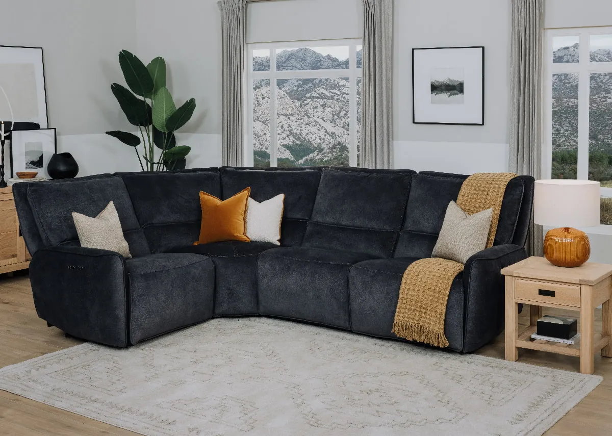 A lifestyle image of the Quentin small corner sofa with paired with albany lamp table.