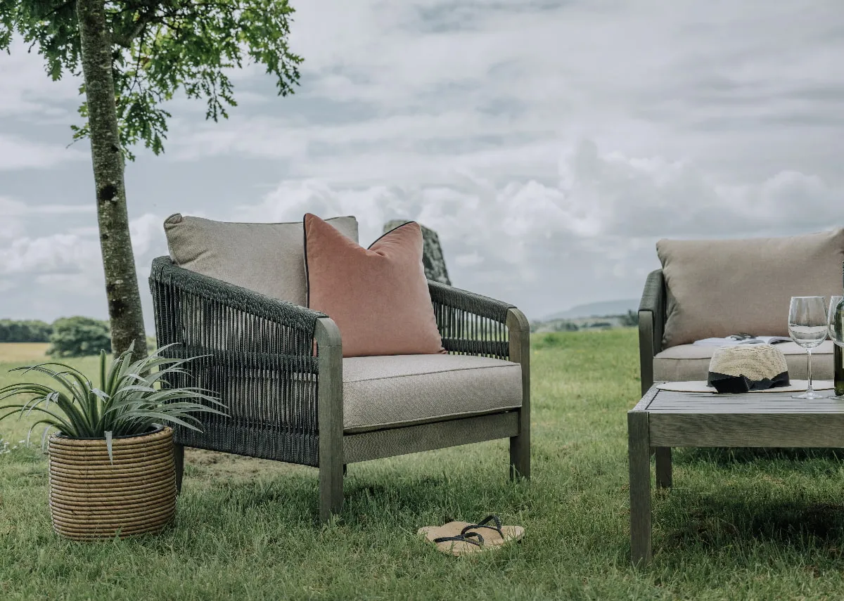 An outdoor lounge set with a 2 seater sofa a table and 2 chairs from EZ Livings Monpellier range. Angled view of 2 seater sofa with light grey removeable cushions.