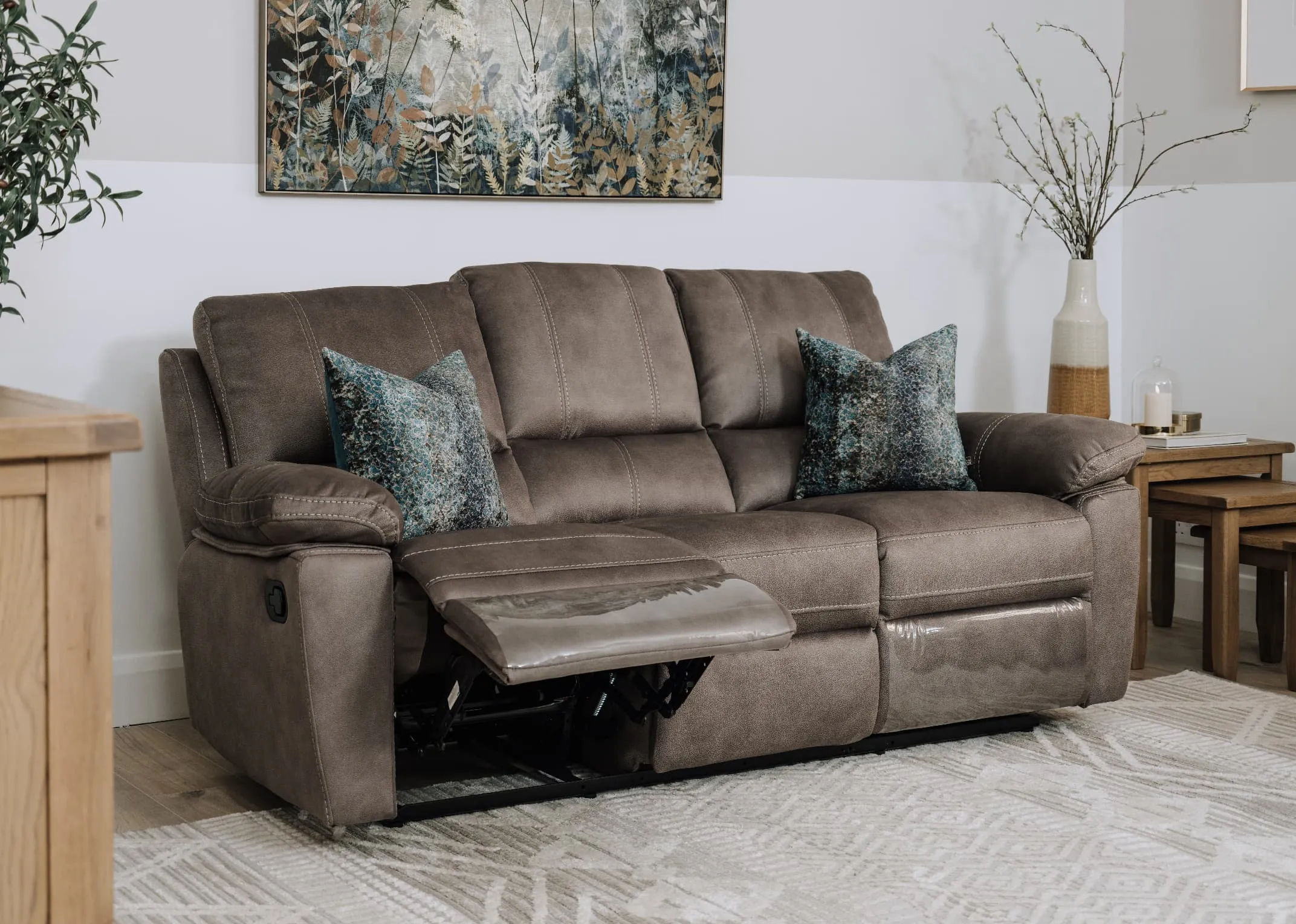 A lifestyle image of the Michigan 3 Seater reclined with the Country cottage side tables.