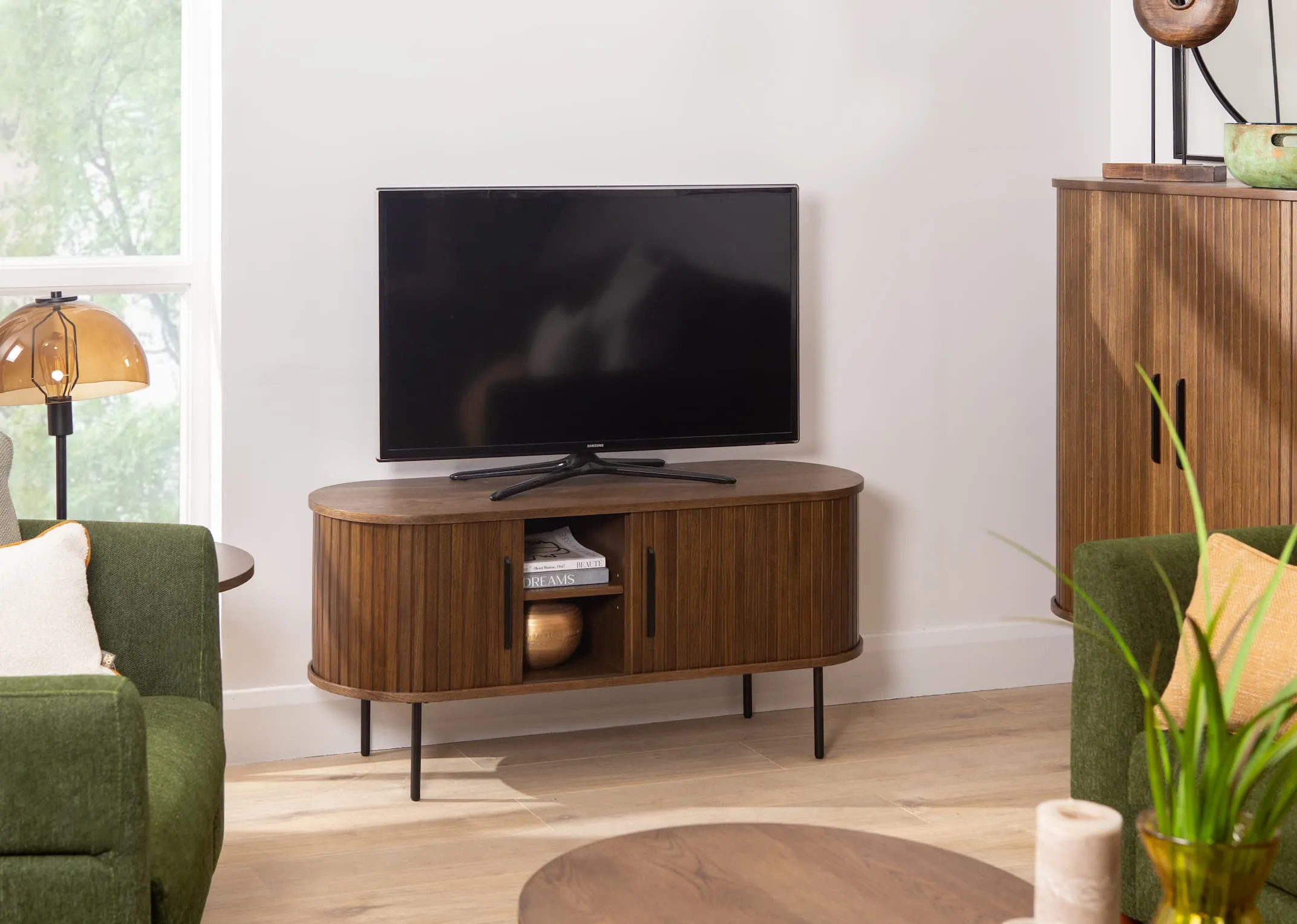 A lifestyle image of the Nola smoked oak tv unit open from EZ Livings Living Range.