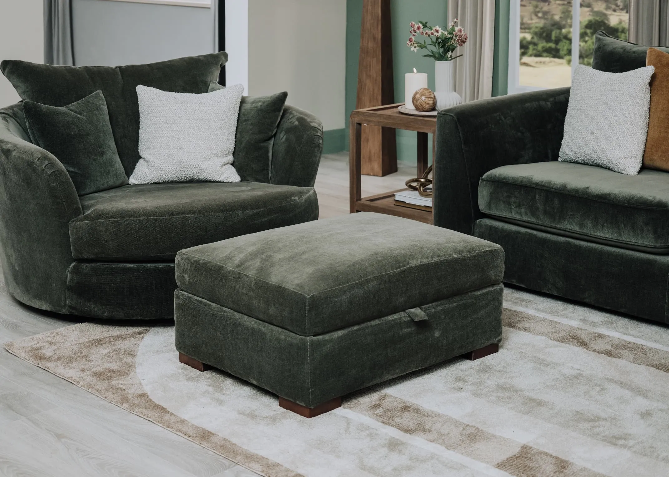 A lifestyle image of the Delilah rug with Lucius footstool in green