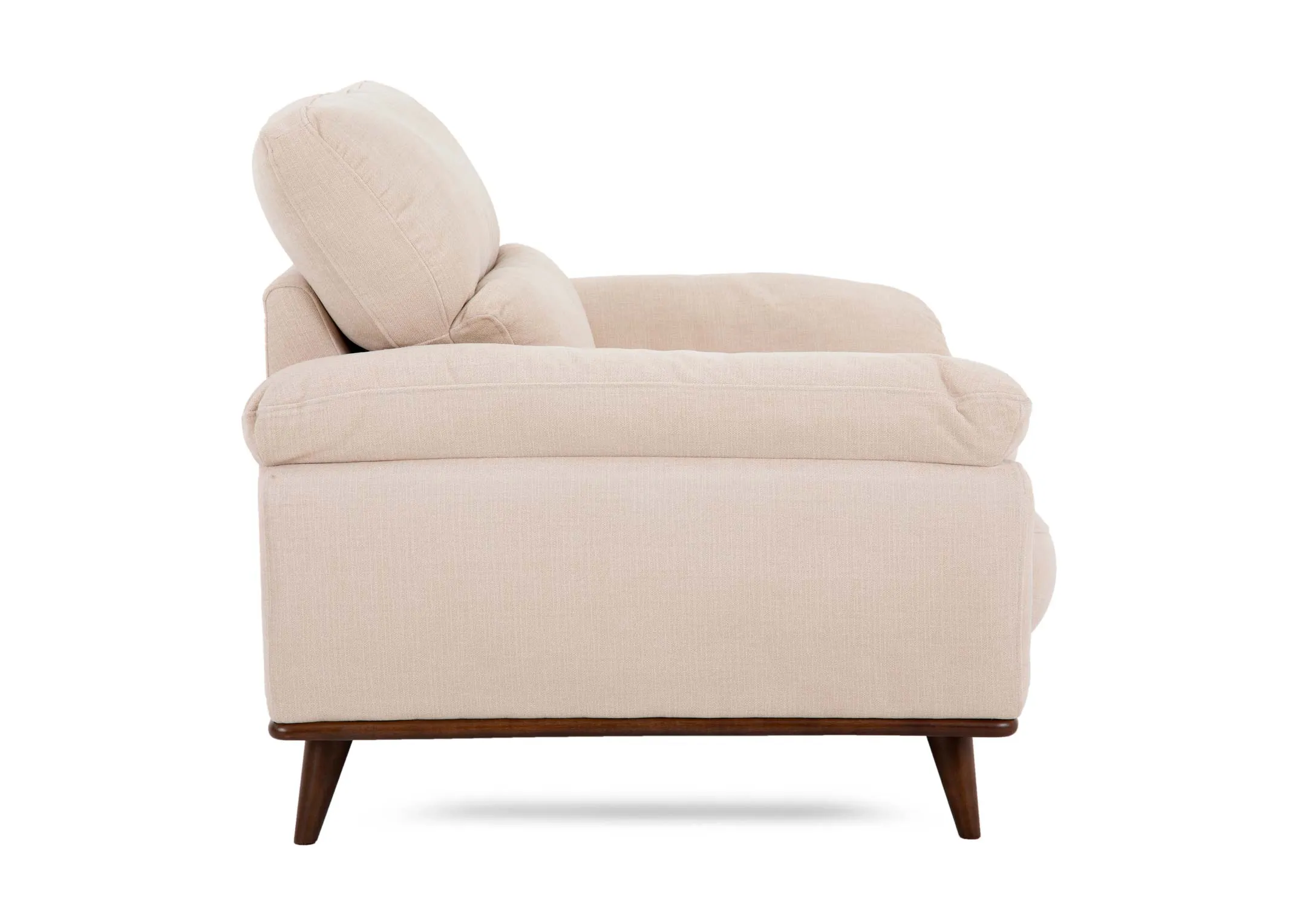 A cream fabric armchair from EZ Livings Pippa range. Side view of low wide arms