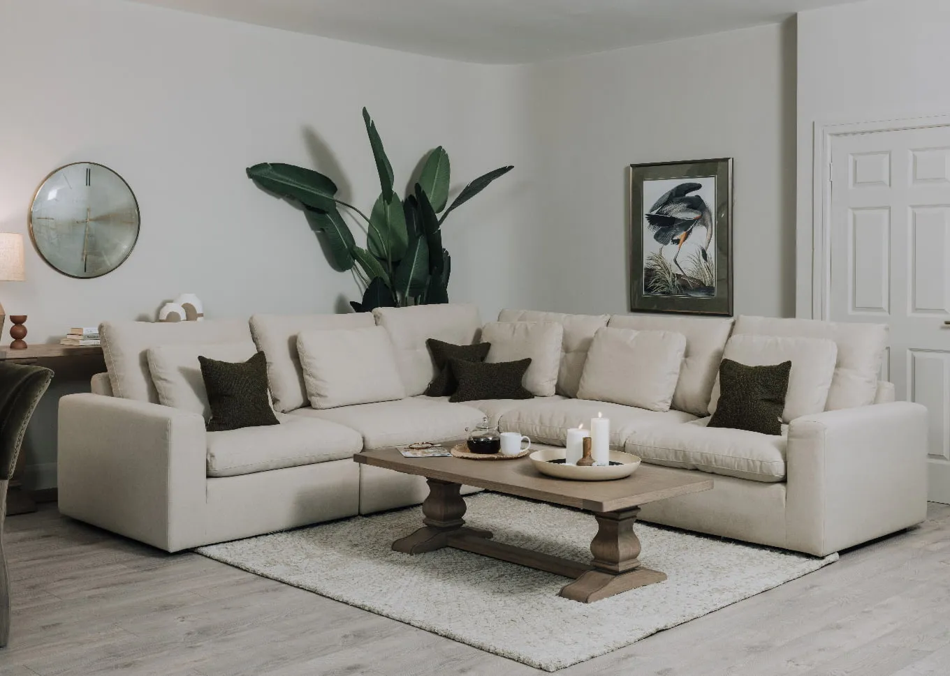 A lifestyle image of the Cozy Corner Sofa with Gold Coast Coffee Table and Heron print
