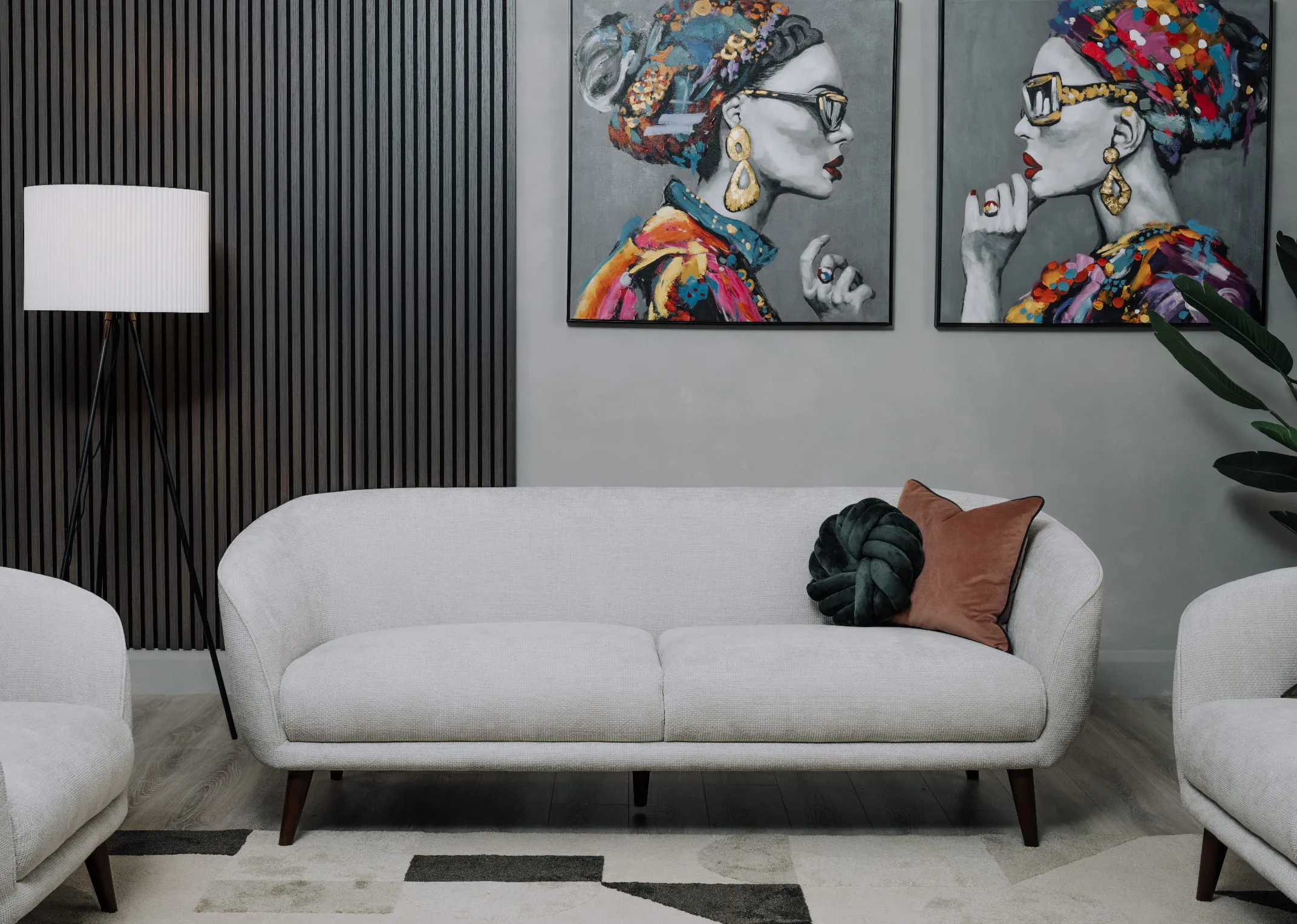 A lifestyle image of the Amber 3 seater sofa with the Contessa prints & Starling lamp.