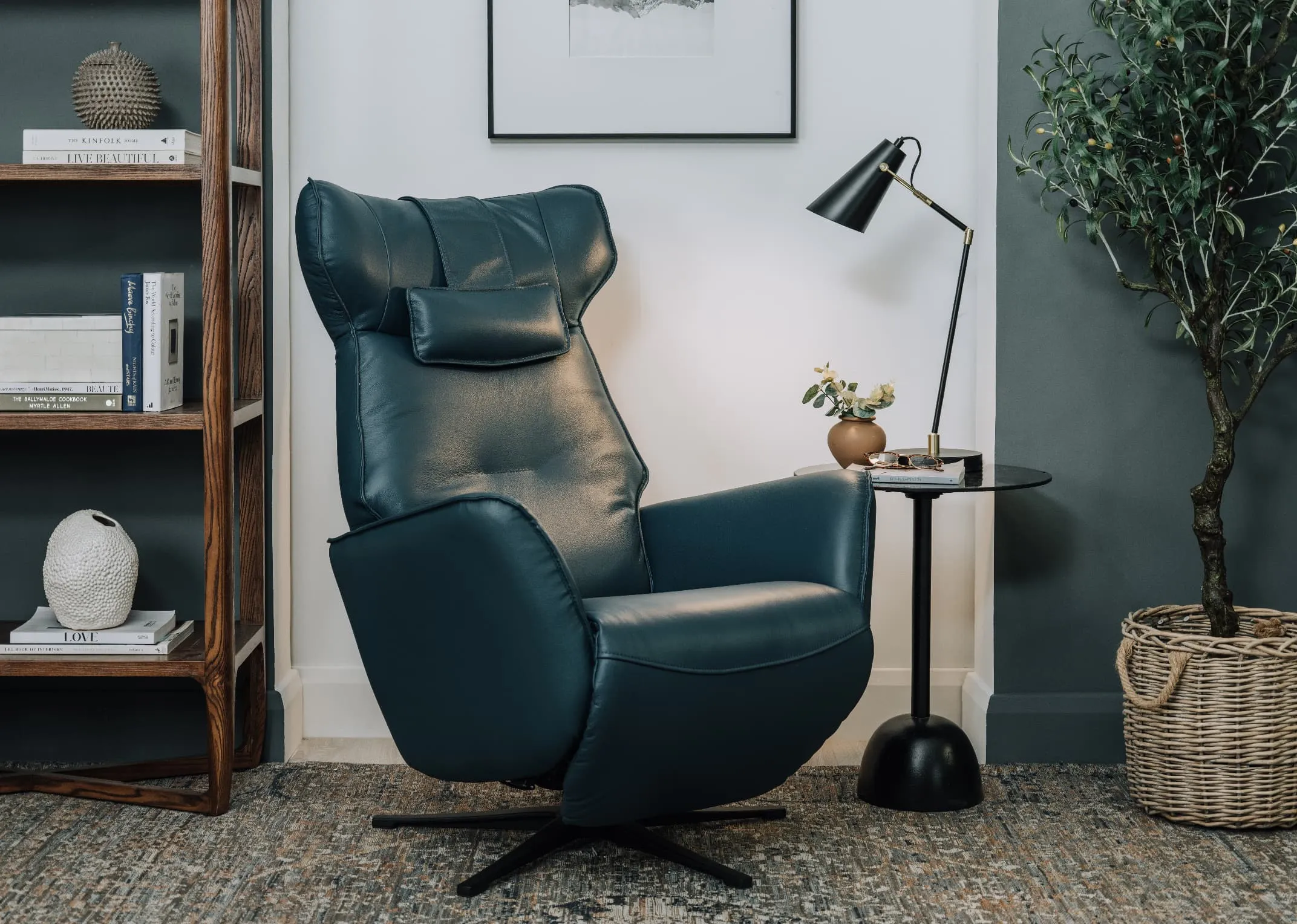 A lifestyle image of the Carrie teal recliner out with massimo table with Husk table lamp.