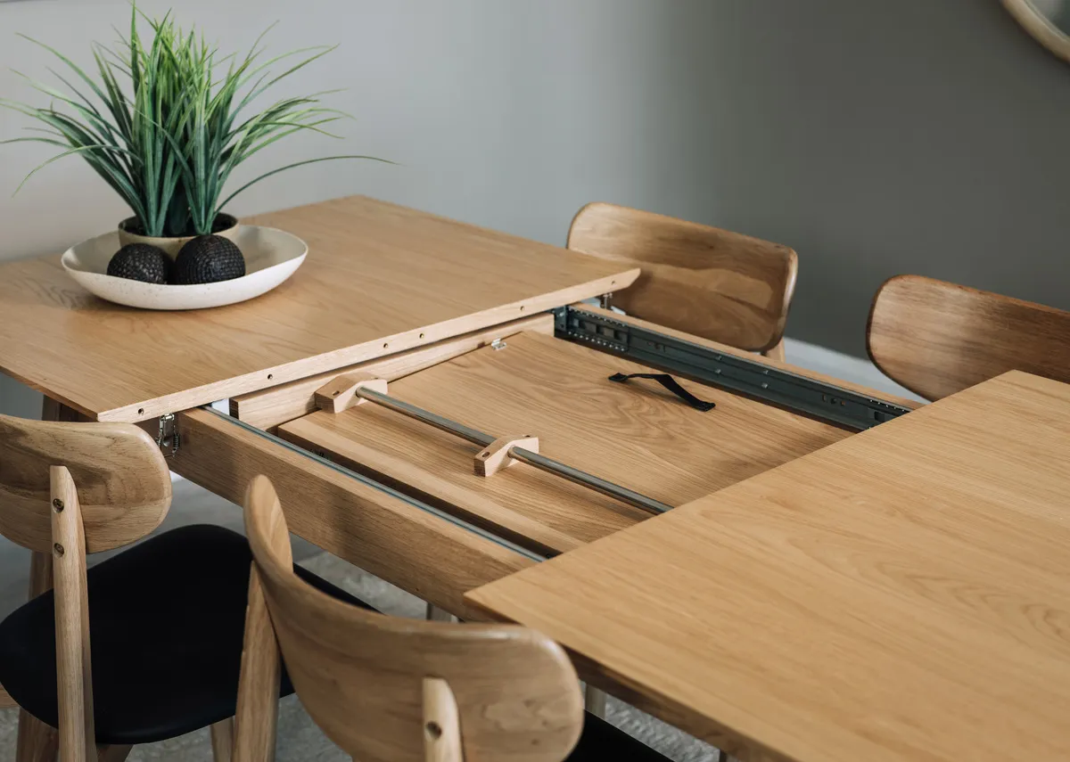 A natural oak dining table from EZ Livings Bari range.Front view of table extended