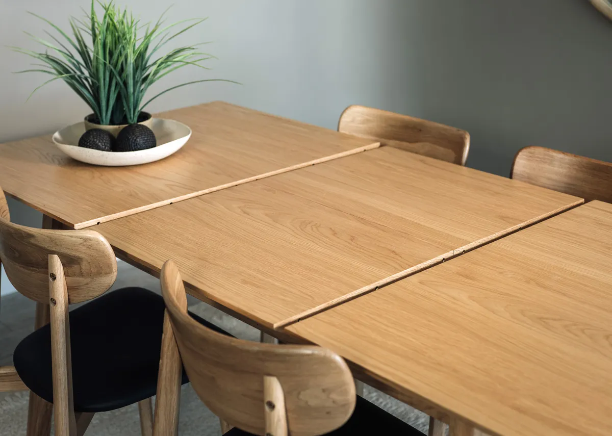A natural oak dining table from EZ Livings Bari range. Side view