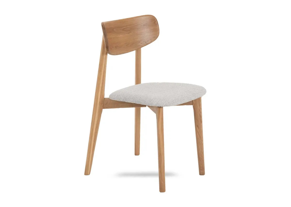 An oak dining chair with cream fabric seat from EZ Livings Bari range. Angled view of curved seat back.