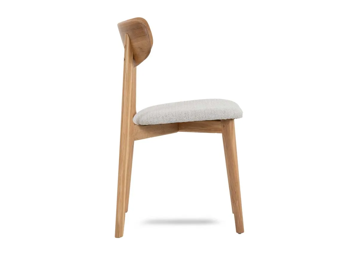 An oak dining chair with cream fabric seat from EZ Livings Bari range.Side veiw of long tapered legs