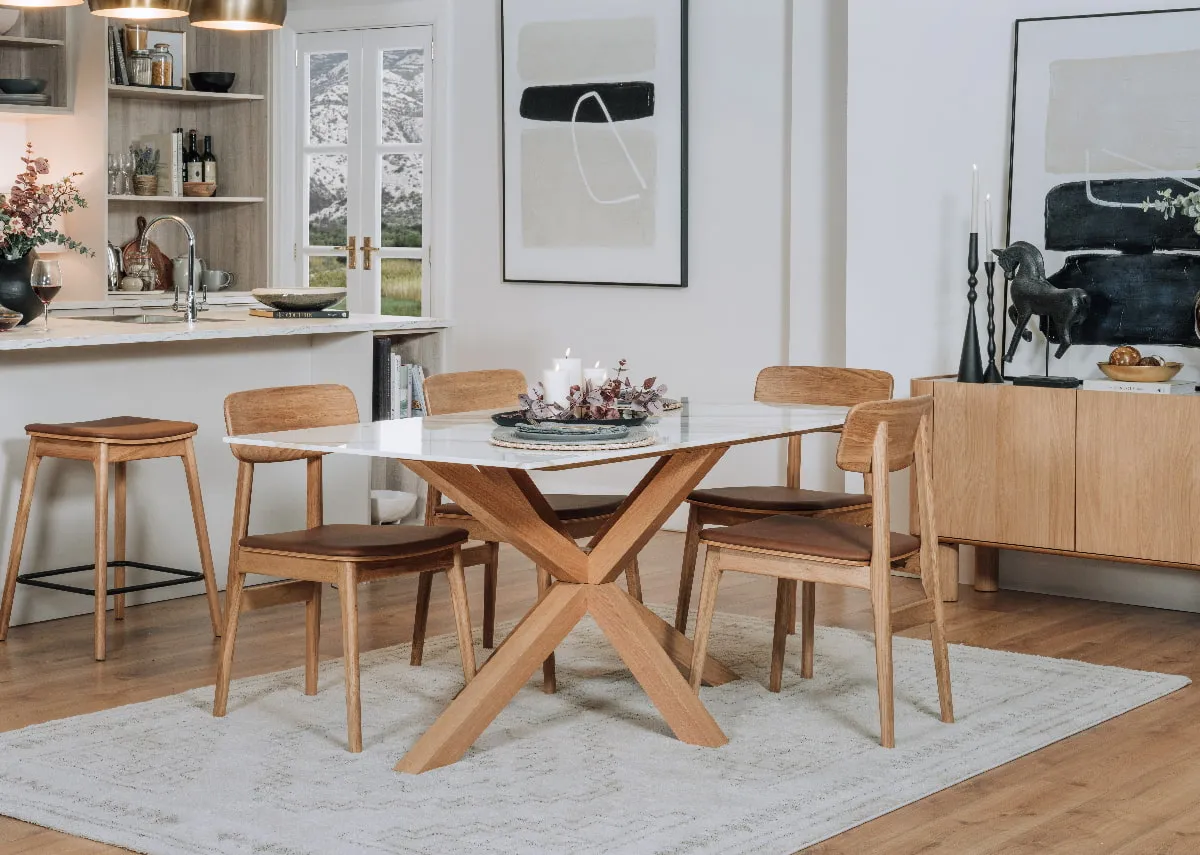 A lifestyle image of the Ravello table with 4 dining chairs and sideboard in a kitchen setting.