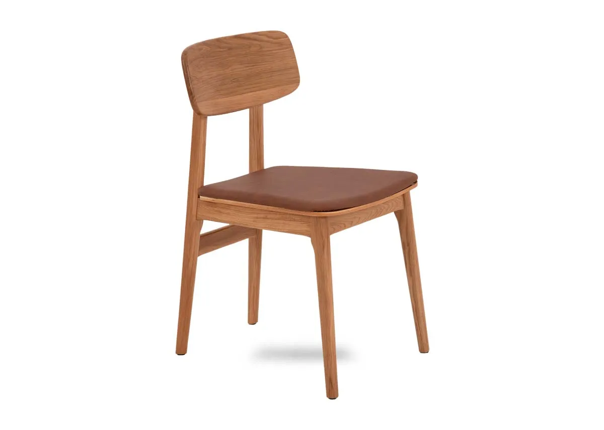 An oak framed dining chair with tan pu seat from EZ Livings Ravello range. Angled view