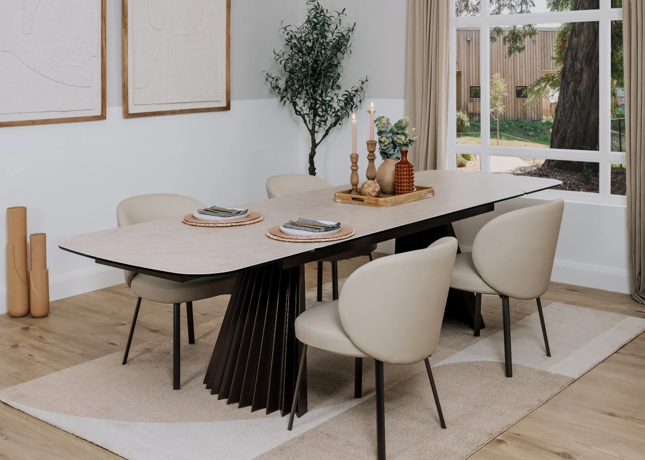 A lifestyle image of the Fulton dining table extended with Lorenzo chairs and Creation rug.