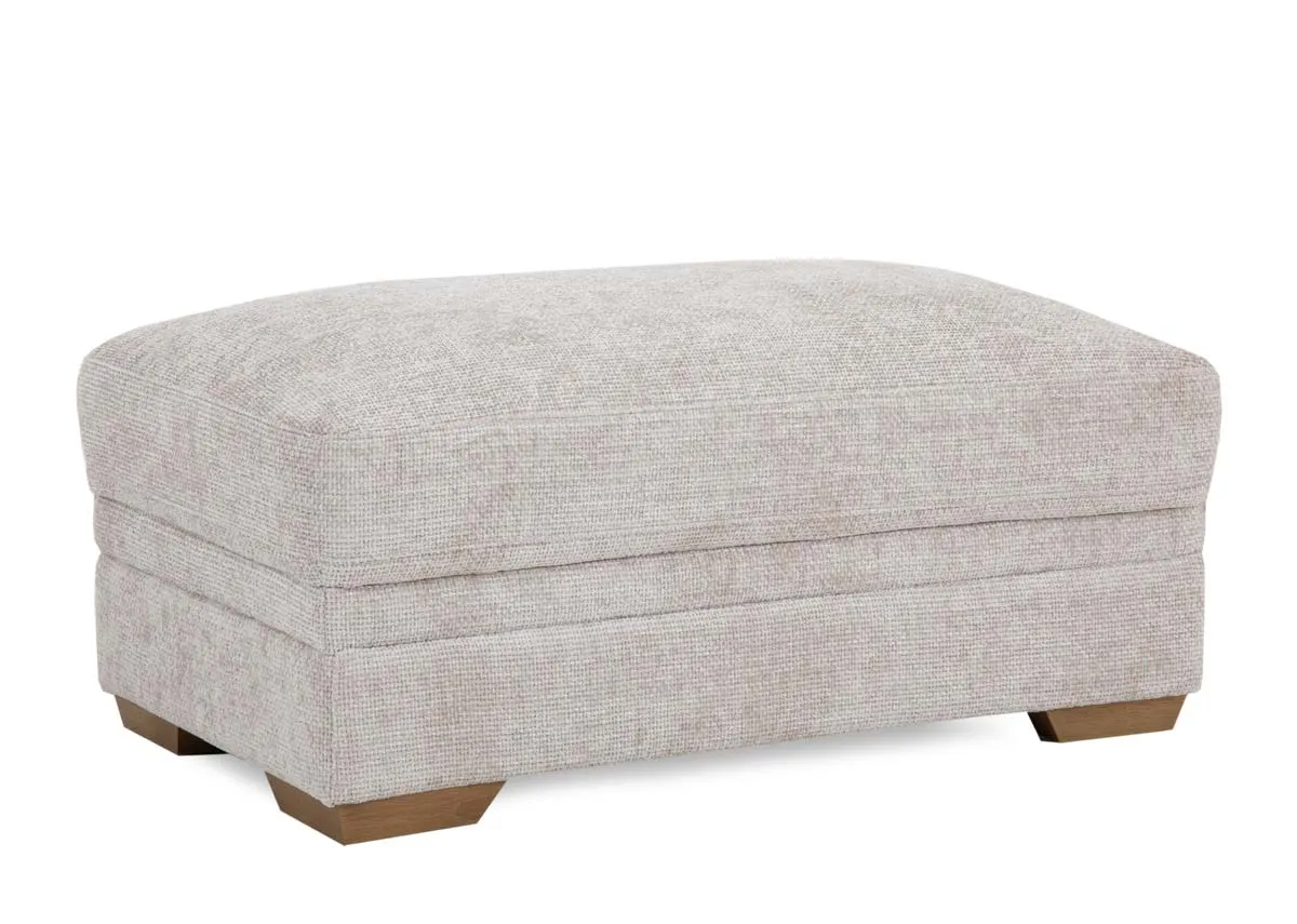 A large beige fabric rectangular footstool from EZ Livings Skyline range. Angled view.