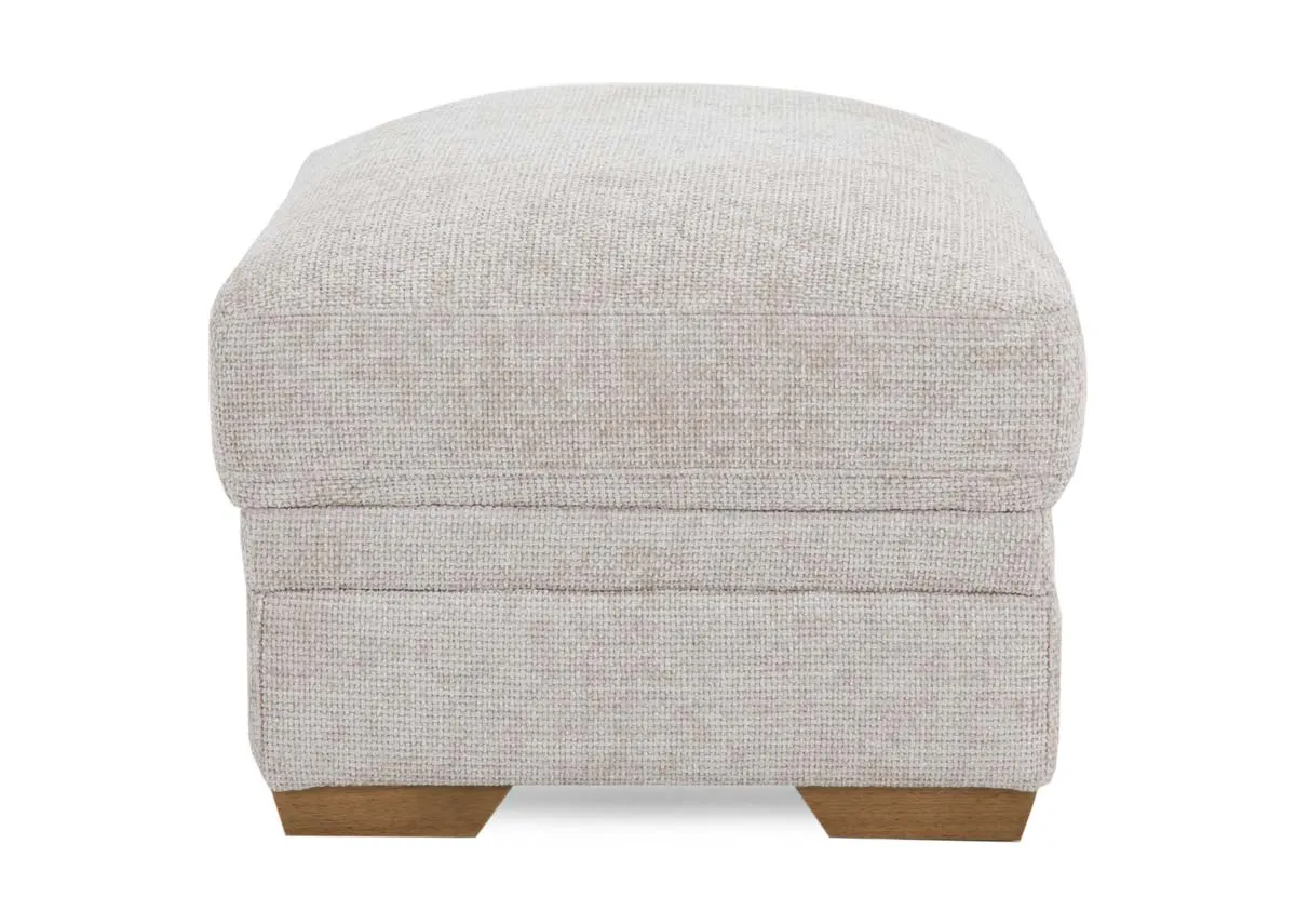 A large beige fabric rectangular footstool from EZ Livings Skyline rangeSide view of oak feet