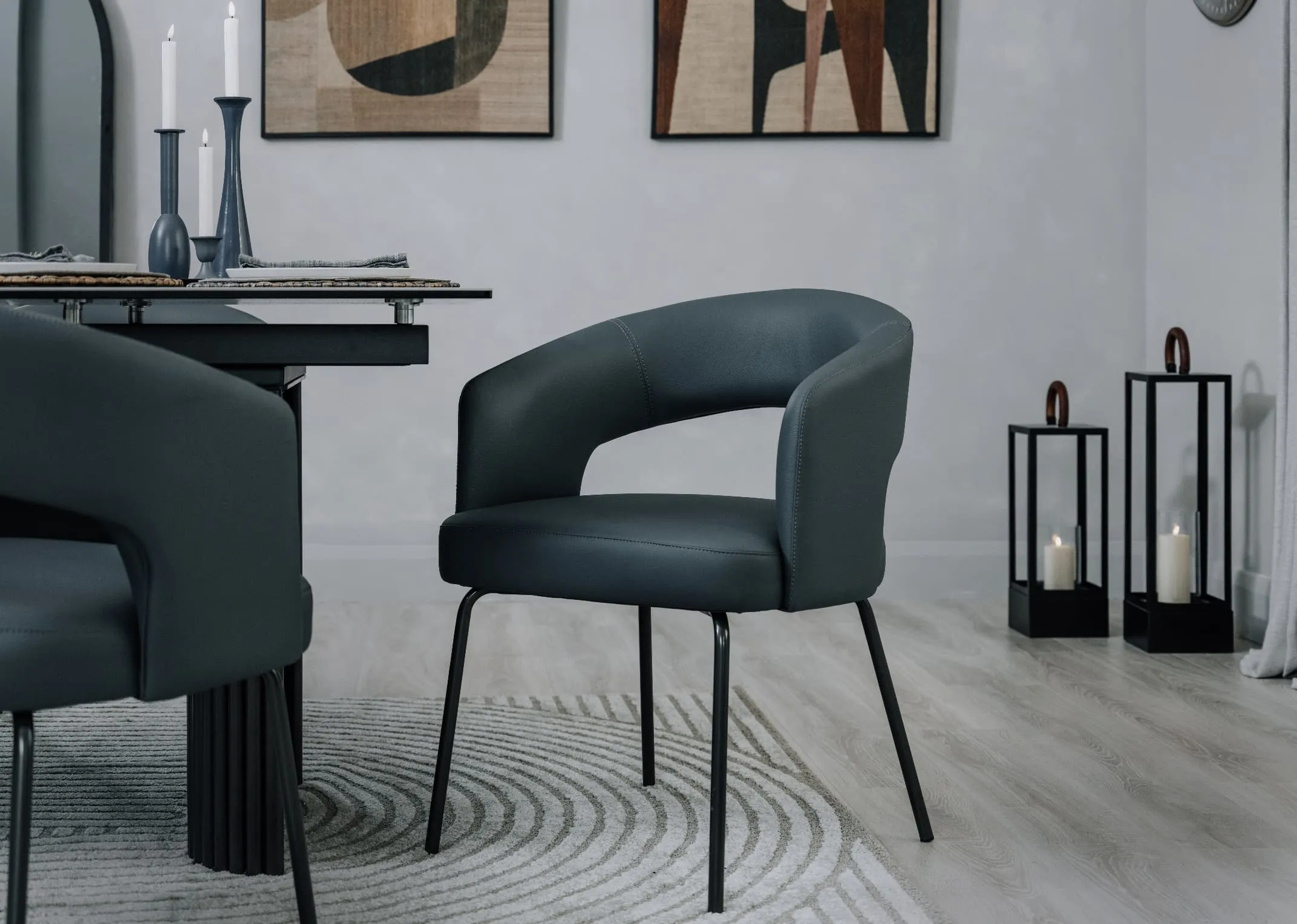 A lifestyle image of the Matteo grey faux leather dining chair with Kingston dining table and modesto rug.
