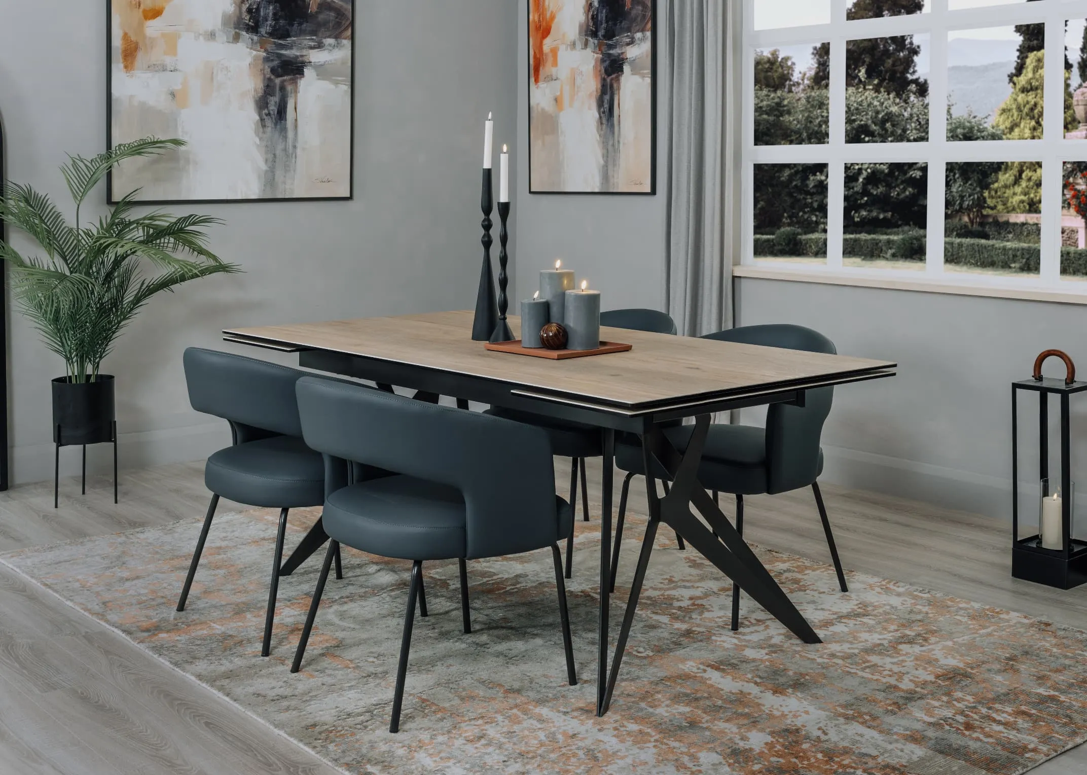 A lifestyle image of the Matteo blue leather dining chair with Kingston dining table and modesto rug.