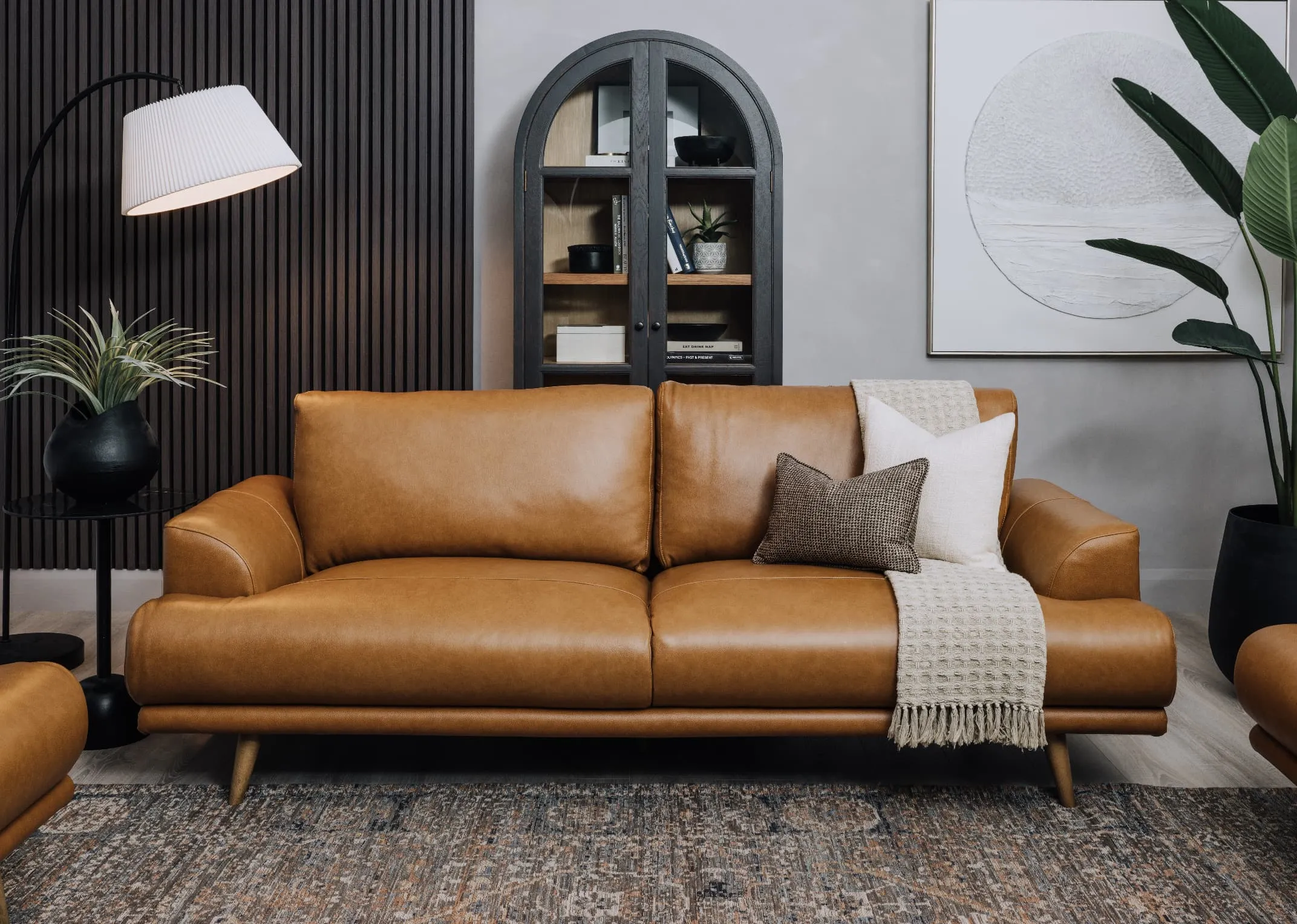 A lifestyle image of the Legend Brown 3 seater with Maxima rug and Juliet Cabinet.