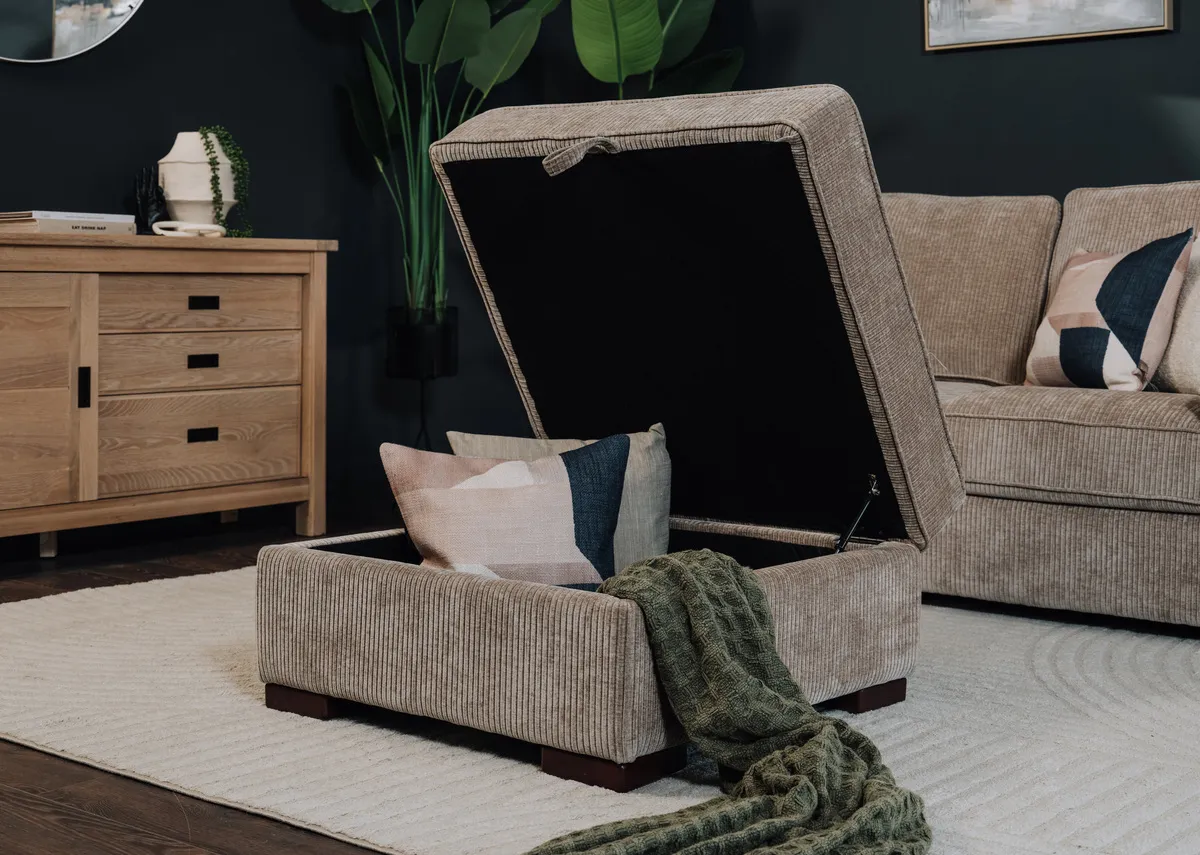 A lifestyle image of the Westport ottoman open showing space for cushions and or throws.