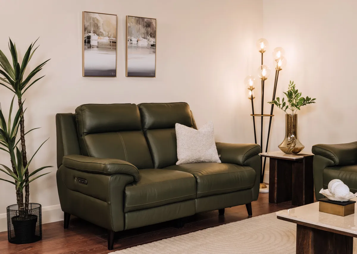 A lifestyle image of the Elliot leather 2 seater sofa fixed with Misty View and Peacful mooring prints with Bonita table.