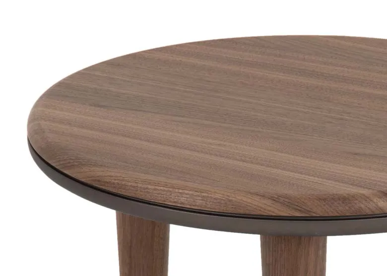 A round walnut side table from EZ Livings Breeze range. Closeup of walnut veneers finish.