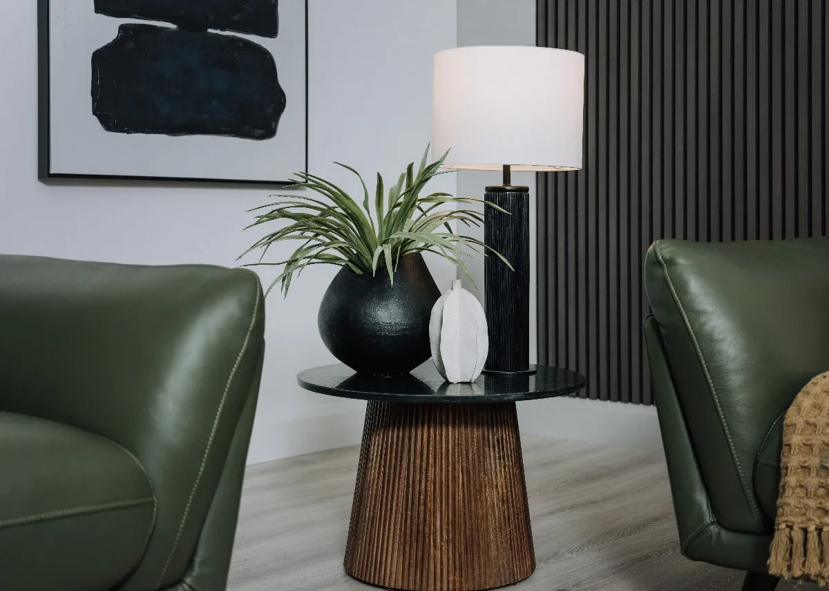 A lifestyle image of the Kira side table with Lohas table lamp with vase.