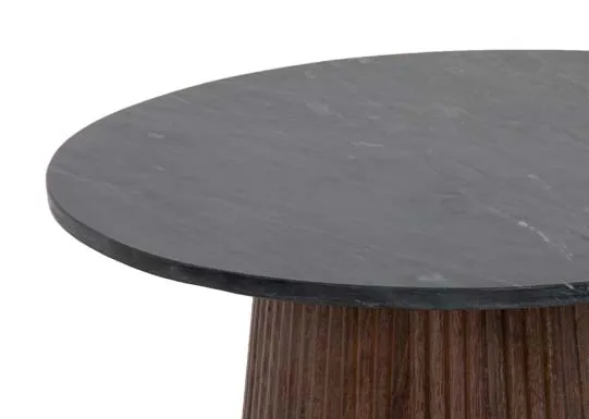 A round mango wood side table with black marble top from EZ Livings Kira range. Closeup of marble top
