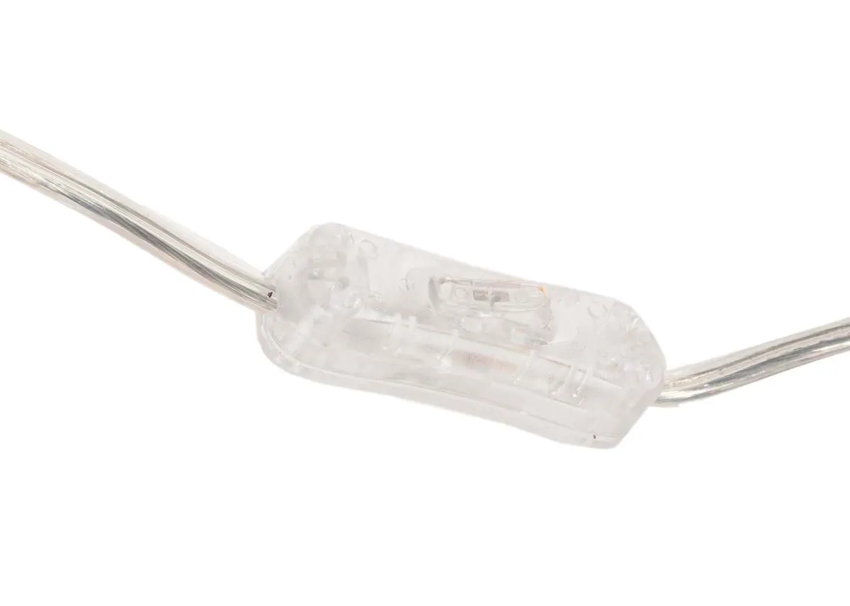 A gold metal table lamp with White shade from EZ Livings Phoenix range. Closeup of clear cable and inline switch.