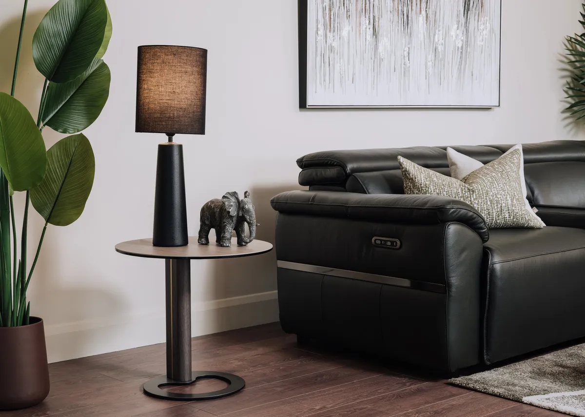 A lifestyle image of the Blanc sie table with blackwater lamp with Moreno sofa.