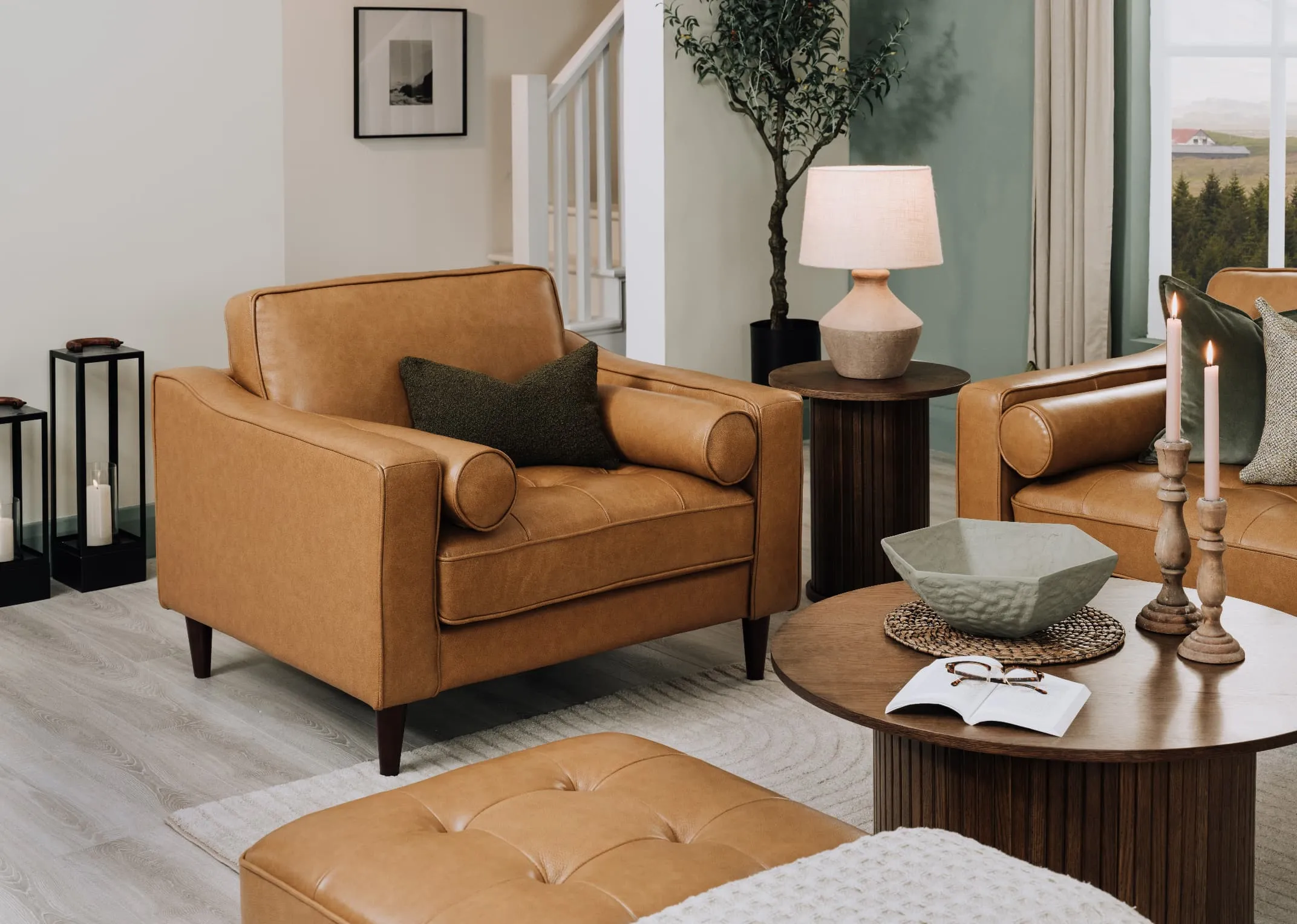 A lifetsyle image of the Genoa armchair with benbulbin cushion with Nola side table with Mai Lamp