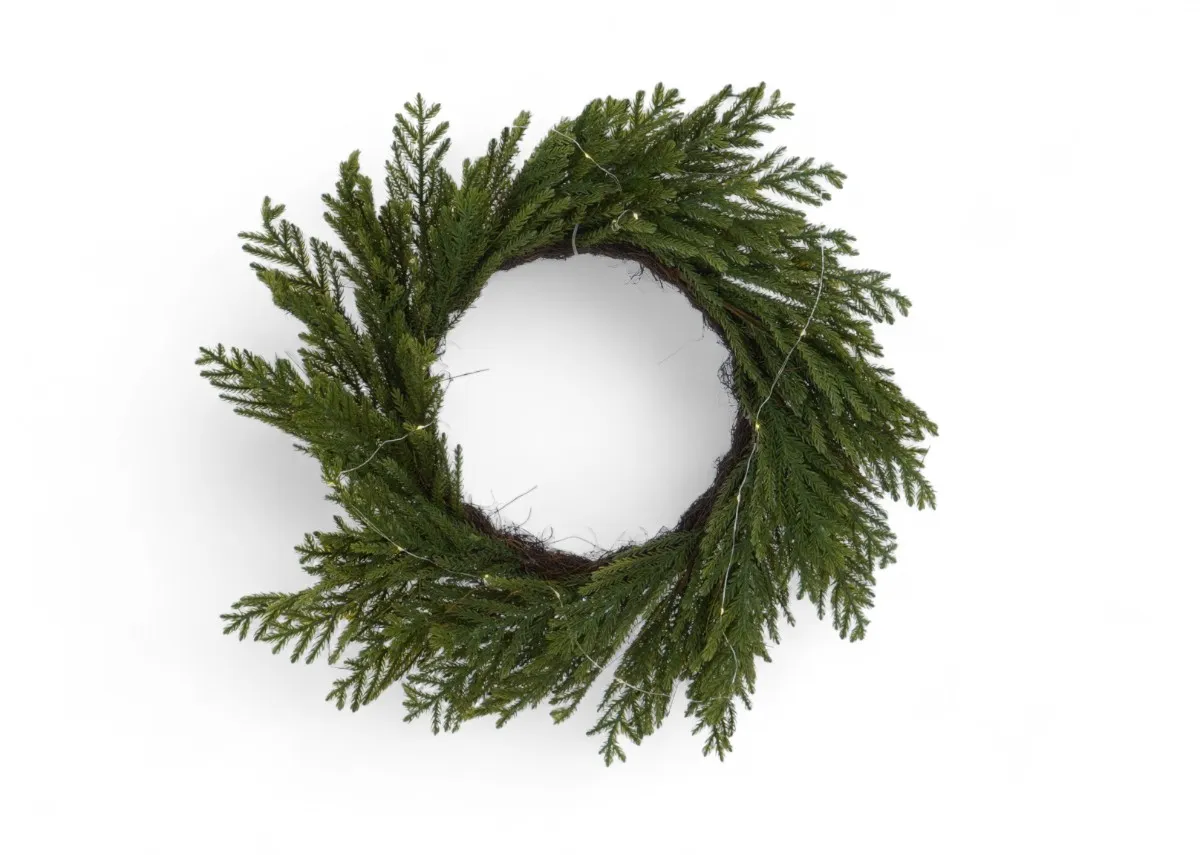 A green wreath with faux needle foligae from EZ Livings Christams range. Front view of wreath unlit.