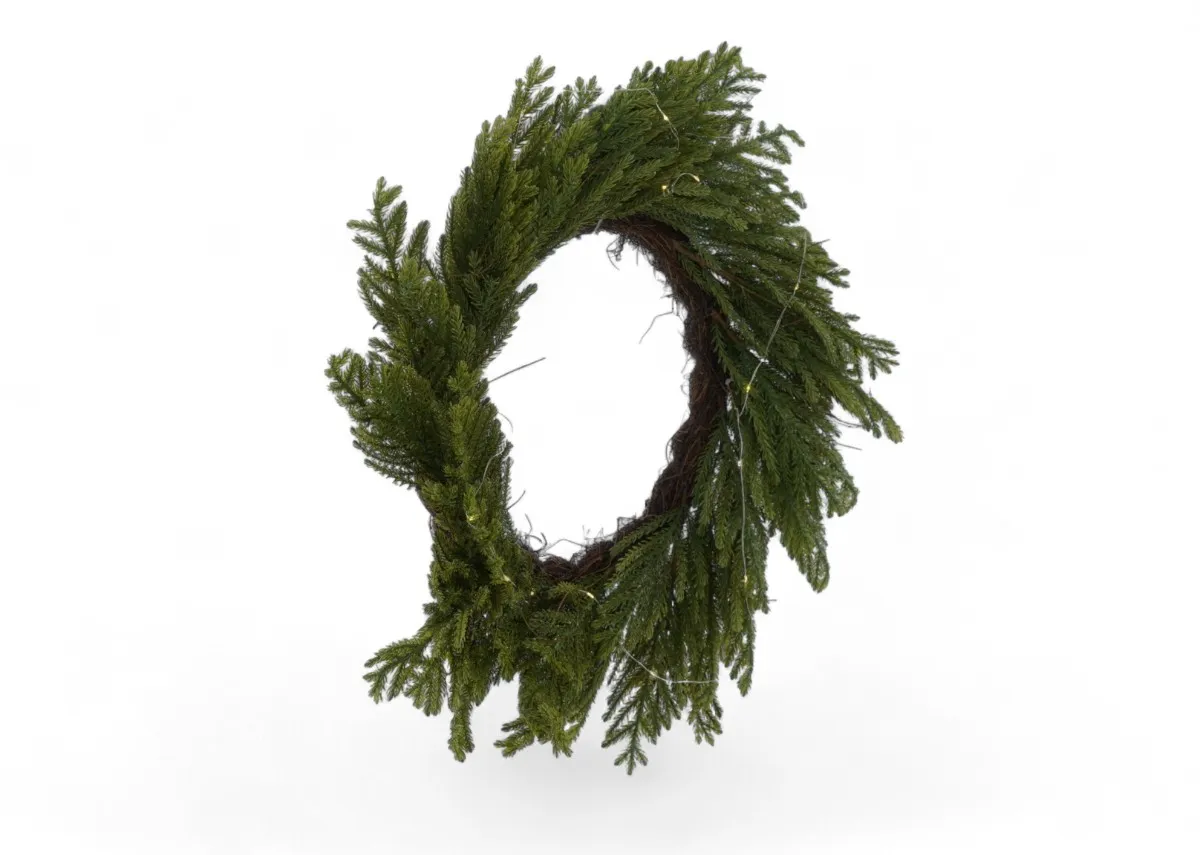 A green wreath with faux needle foligae from EZ Livings Christams range. Front view of wreath unlit.