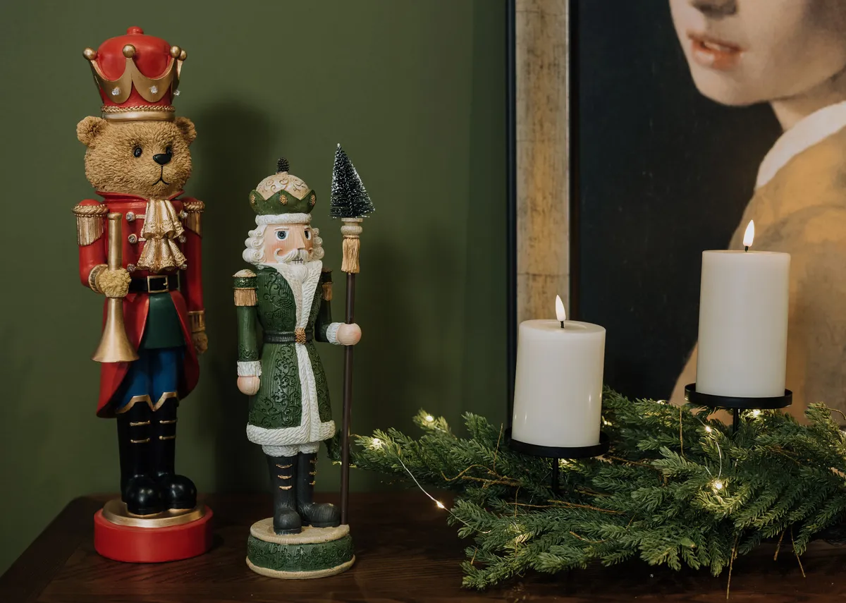 A lifestyle image of the King John nutcracker with teddy on a sideboard.