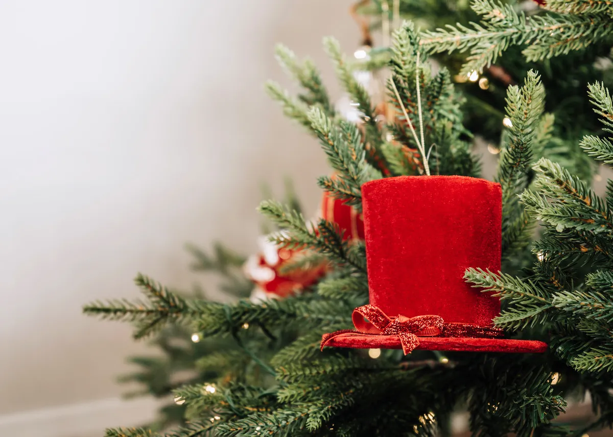 A lifestyle image of the Red Top hat bauble on the Douglas tree.
