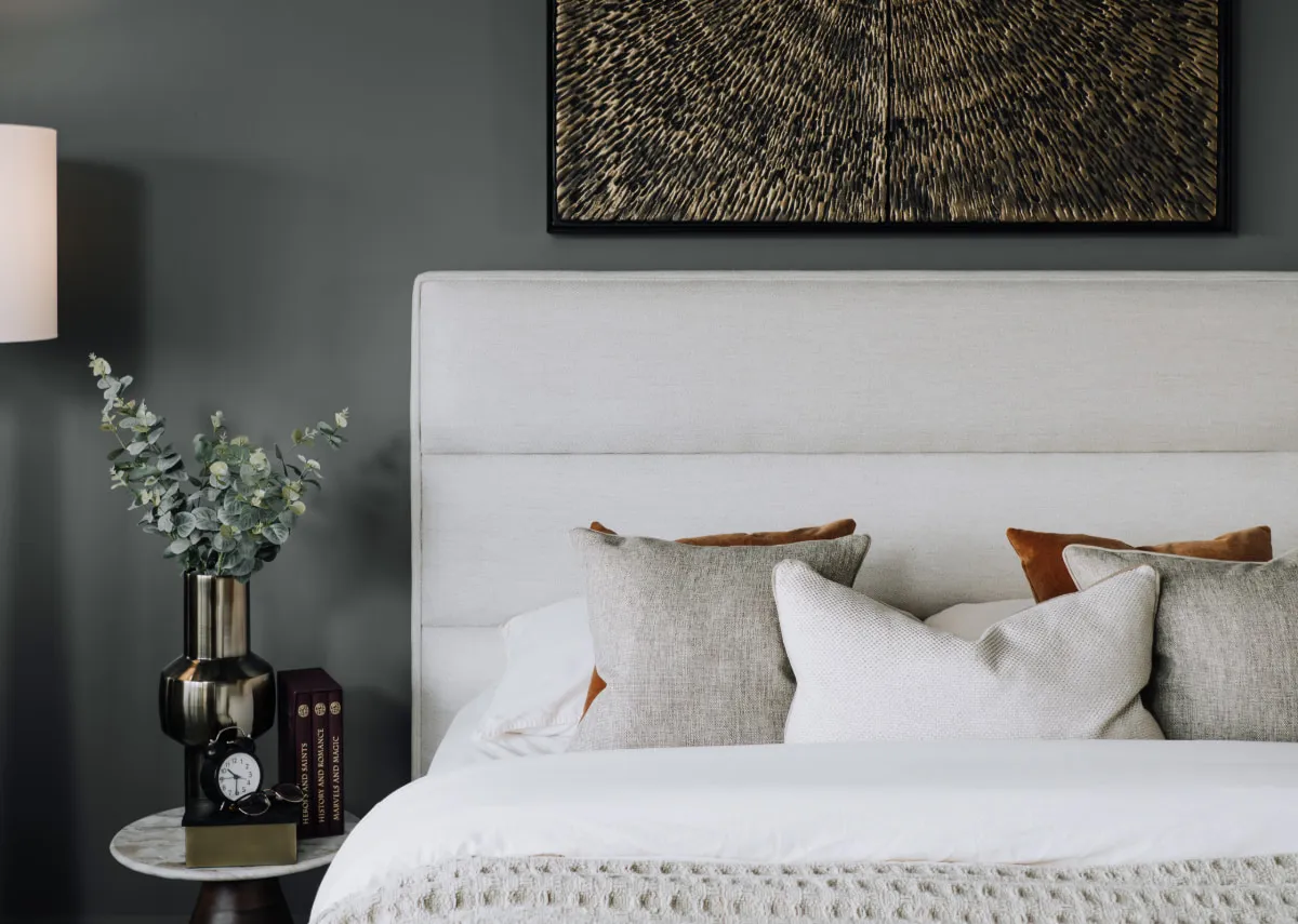 A lifestyle image of the Ebony beige bed with a detail closeup of the seamed headboard