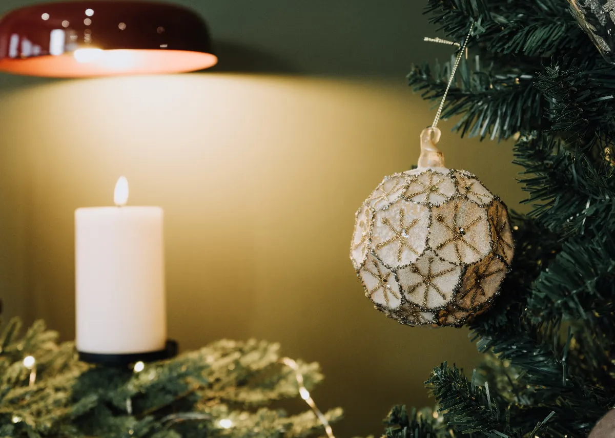 A lifestyle image of the Jingle Bells Rock bauble on a tree.