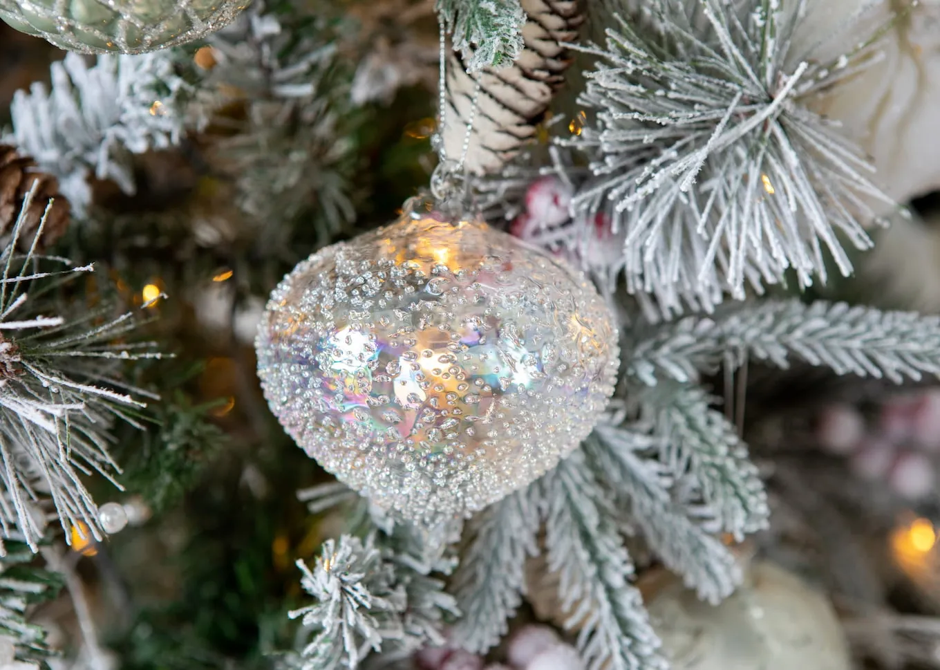 A lifestyle image of the Frosty Bauble on a Christmas tree
