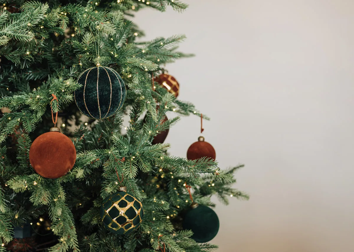 A lifestyle image of the Douglas tree with a selection of green and brown baubles